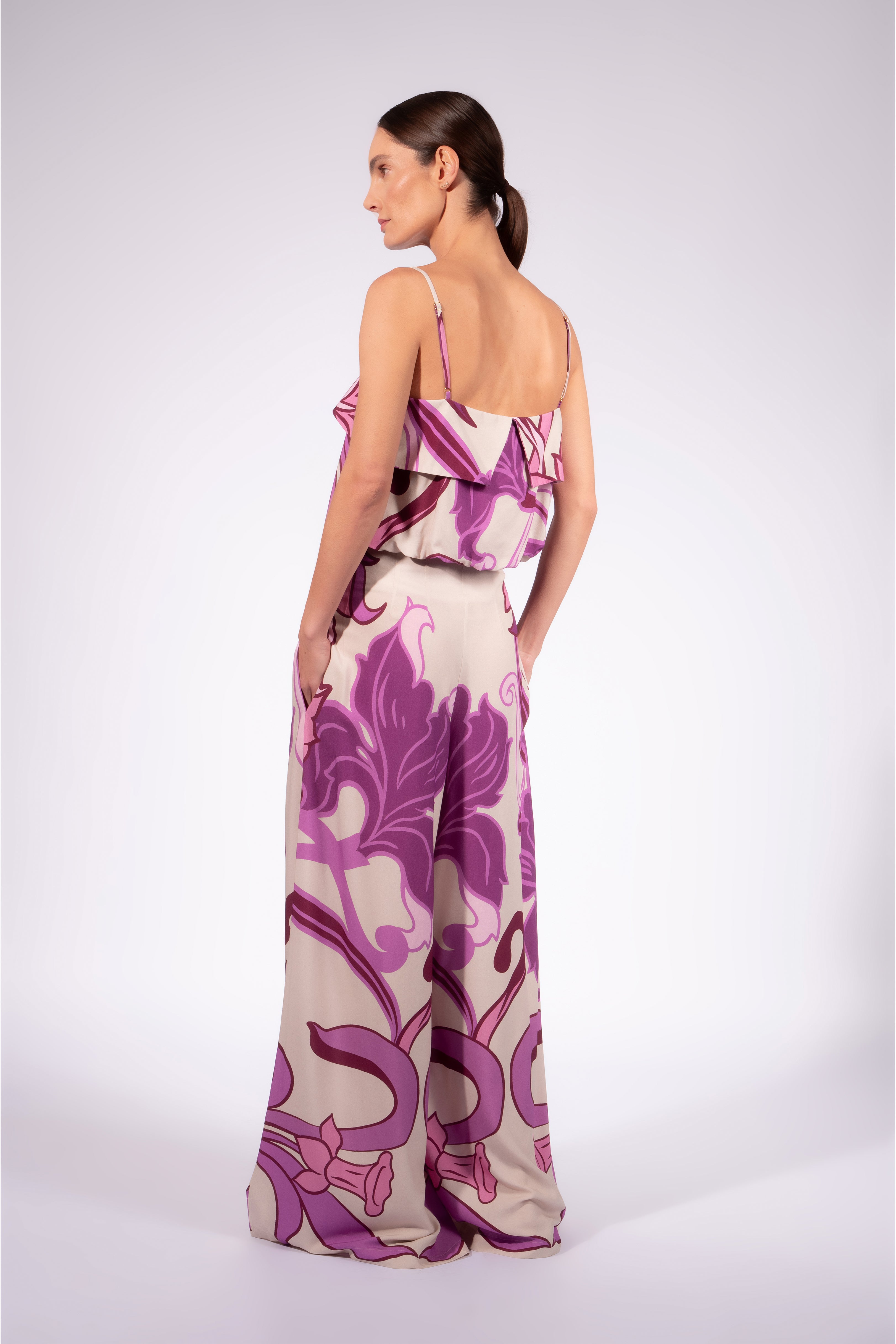 Model wearing the Alpine Flower Wide-Leg Pants back made from 100% viscose fabric, styled for a resort look