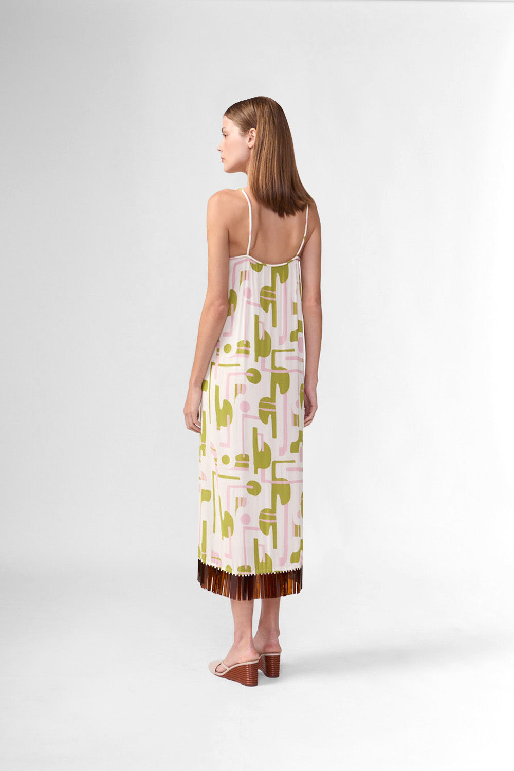 Model wearing the Balearic Acrylic Fringe Midi Dress back, showcasing its unique color made from 100% Viscose fabric, styled for an afternoon look.