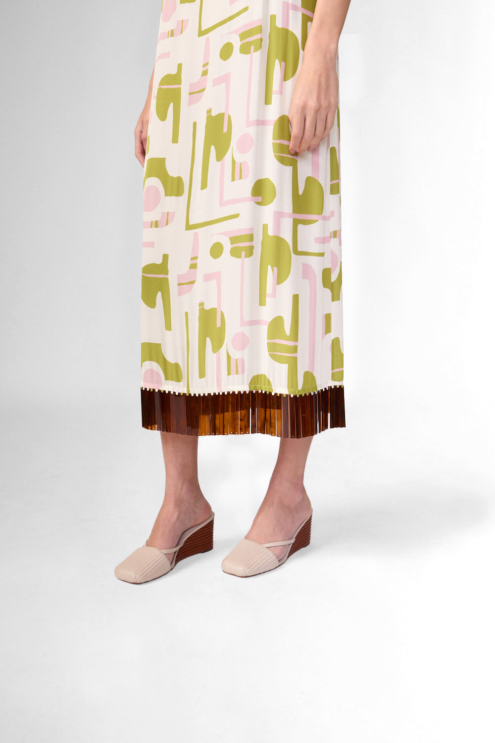 Model wearing the Balearic Acrylic Fringe Midi Dress detail, showcasing its unique color made from 100% Viscose fabric, styled for an afternoon look.