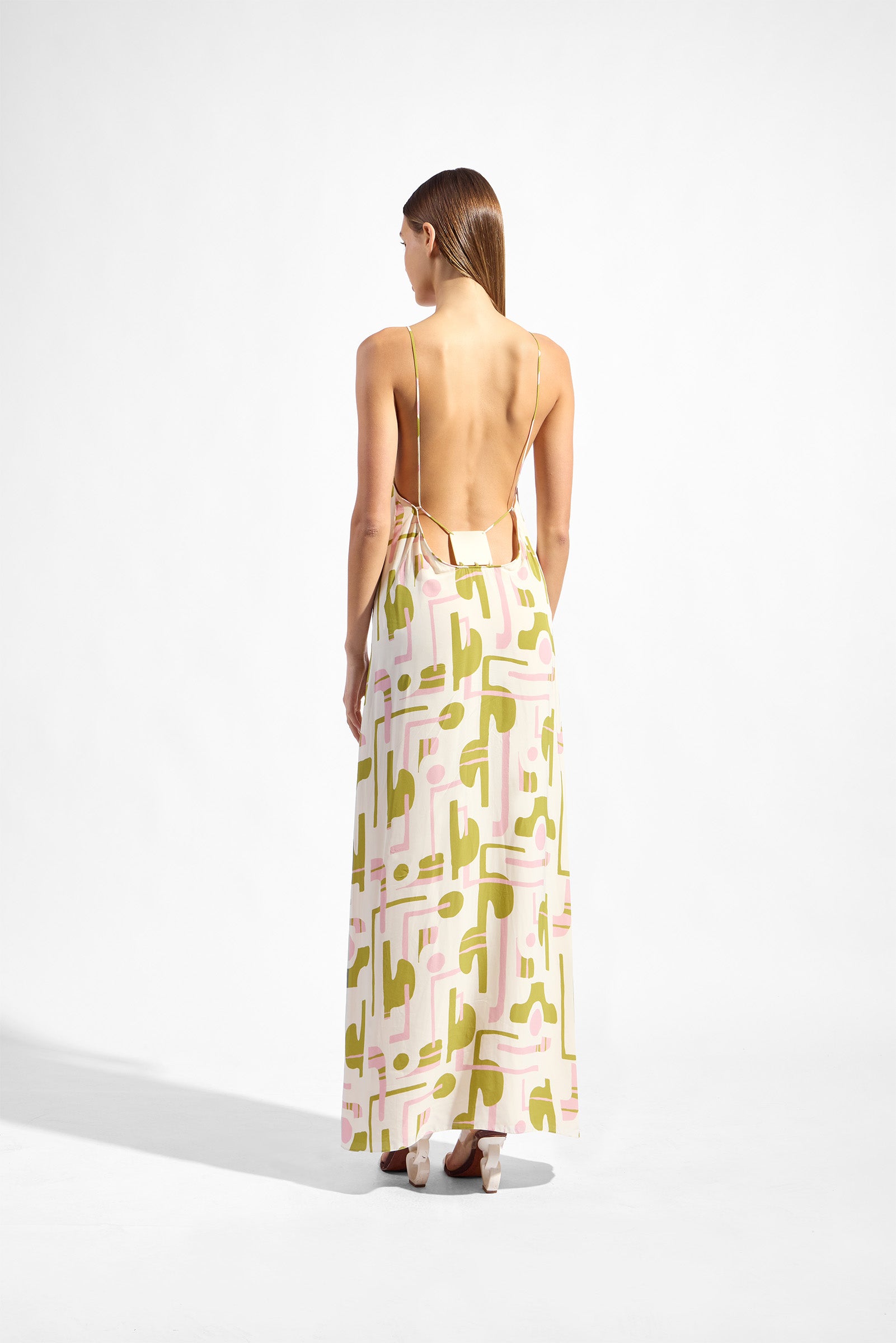 Model wearing the Balearic Bare Back Maxi Dress back showcasing its unique color on 100% Viscose fabric, styled for an evening look.
