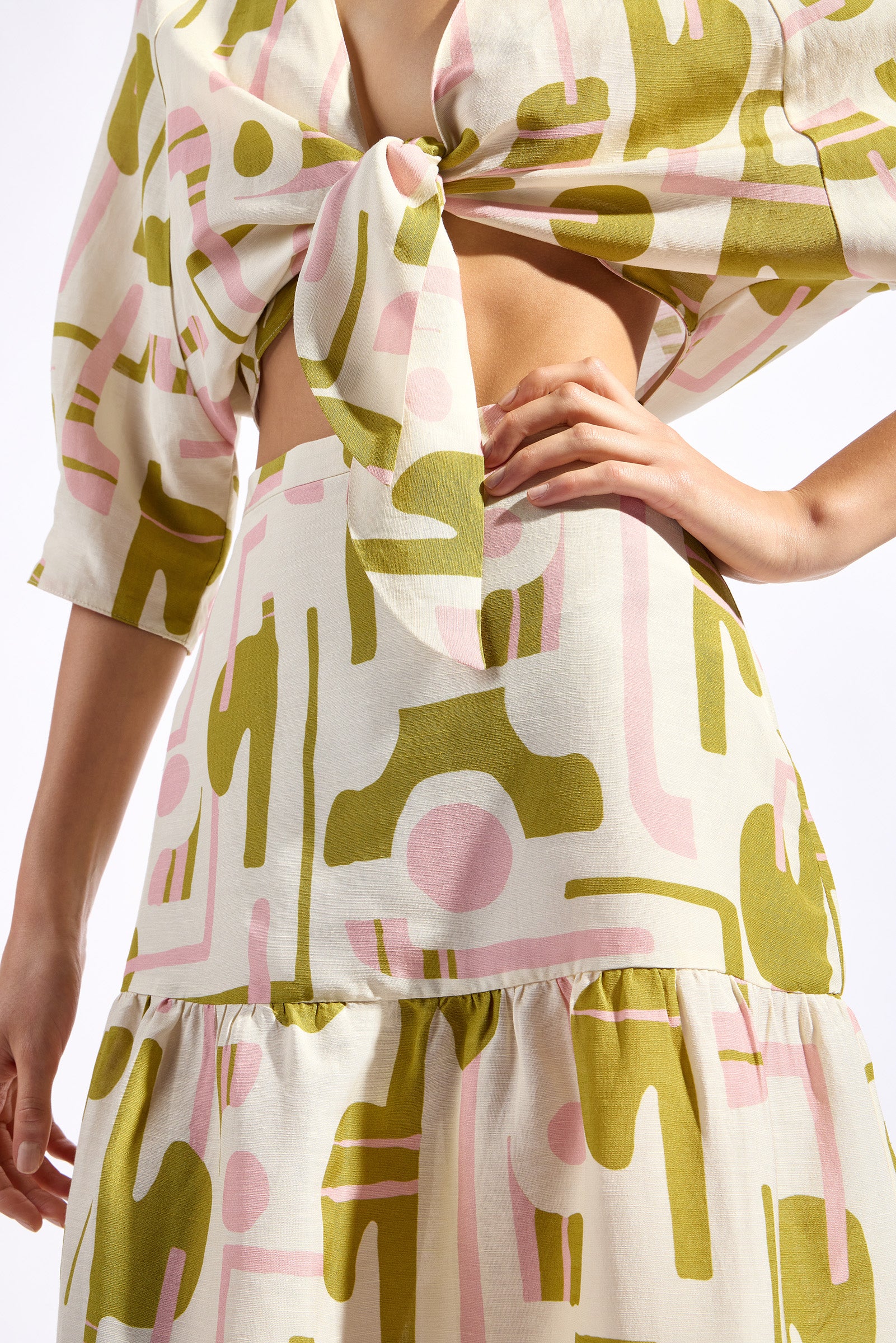 Model wearing the Balearic Front Tie Cropped Top detail color unique made with 56% viscose 44% Linen, styled for resortwear look