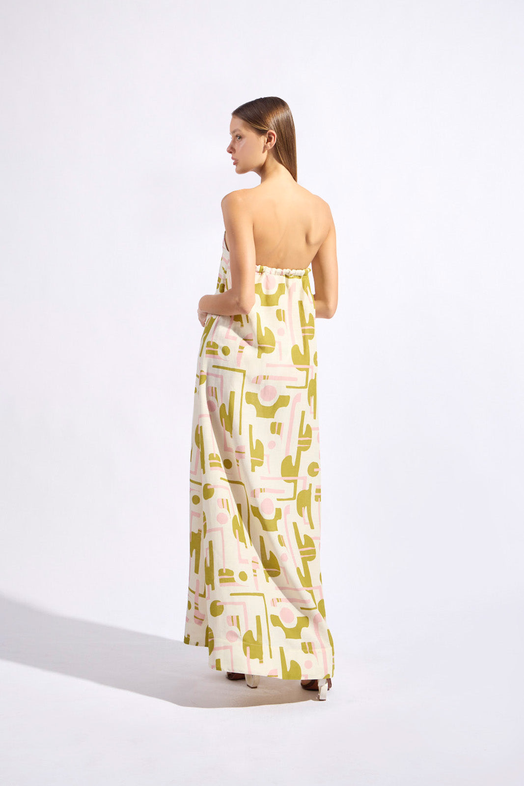 Model wearing the Balearic Strapless Maxi Dress back color unique made with 56% viscose 44% Linen, styled for resortwear look