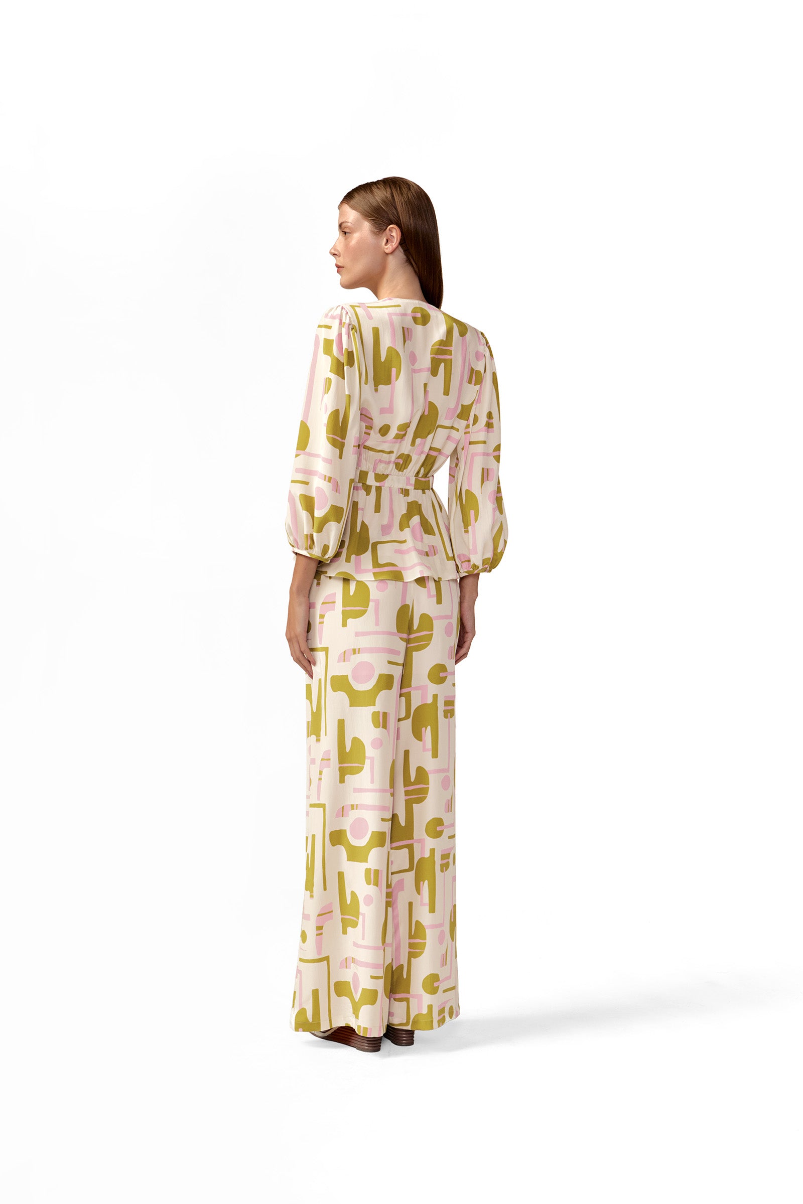 Model wearing the Balearic Wide-Leg Pants back color unique, made with 100% viscose fabric, styled for resortwear look