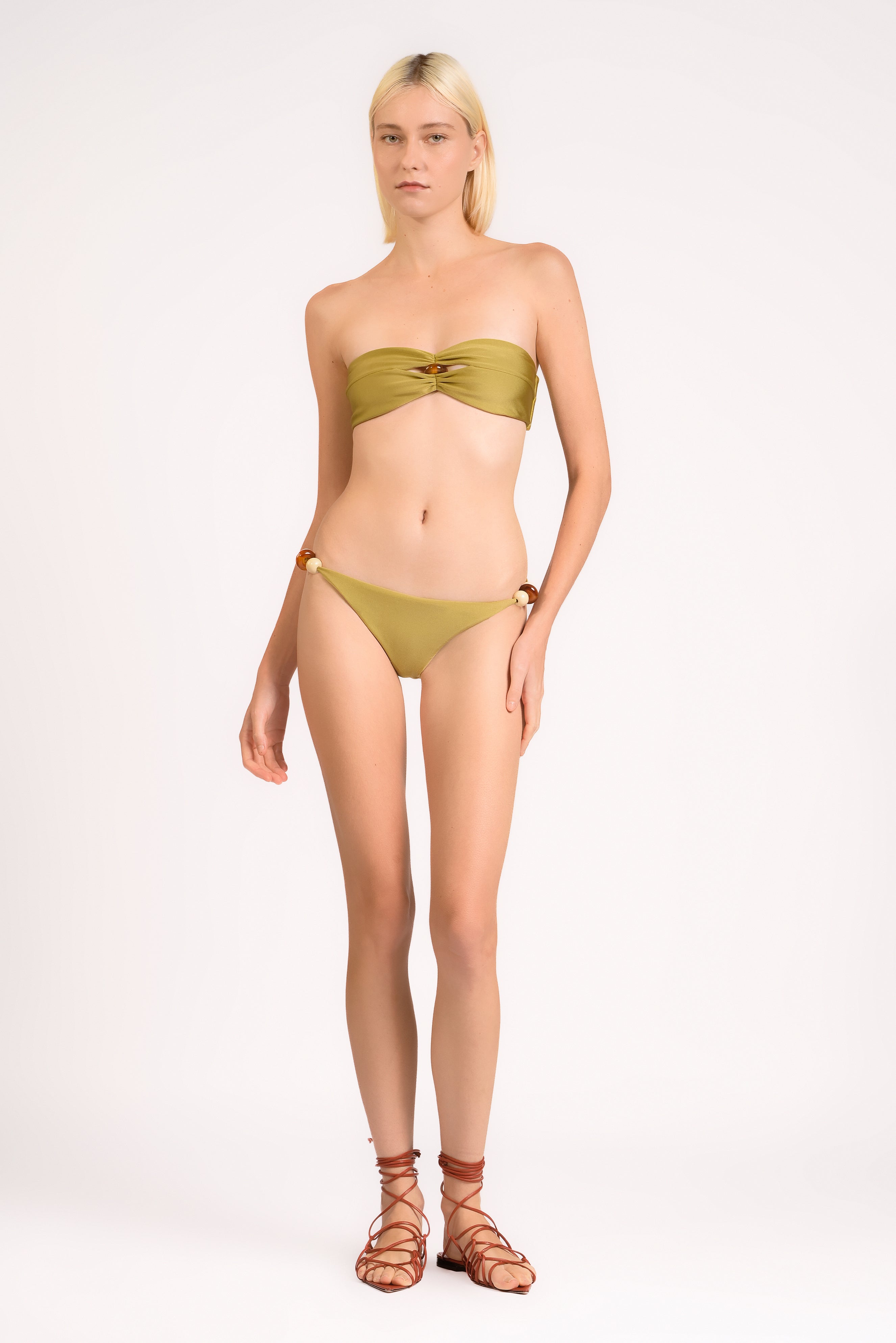 Model wearing the Bandeau Beaded Bikini Set Front color pistachio, made from 85% polyamide 15% elastane, styled for beachwear look