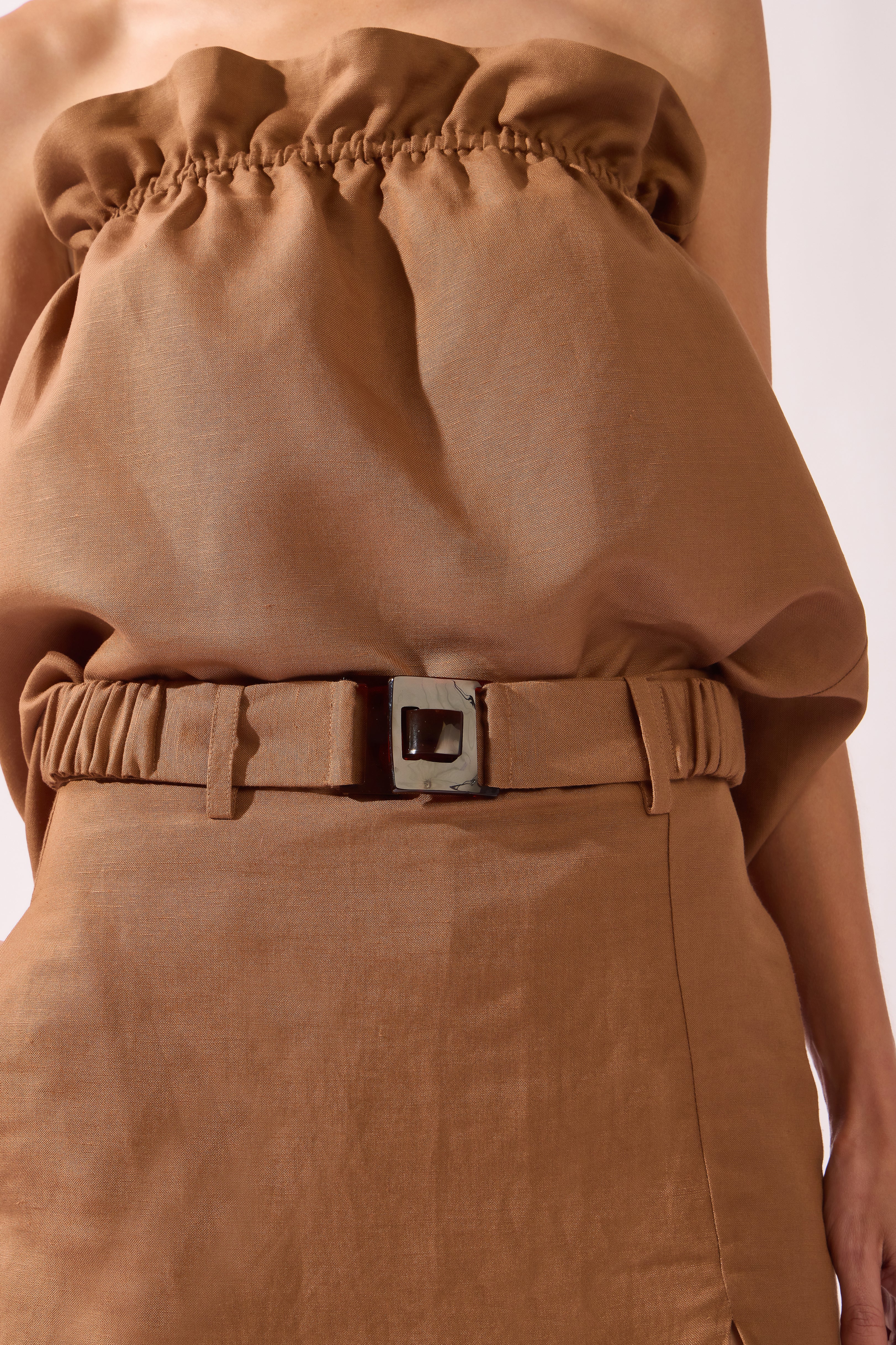Model wearing the Belted Skort front detail color brown, made from 55% linen 45% viscose, styled for a resort look