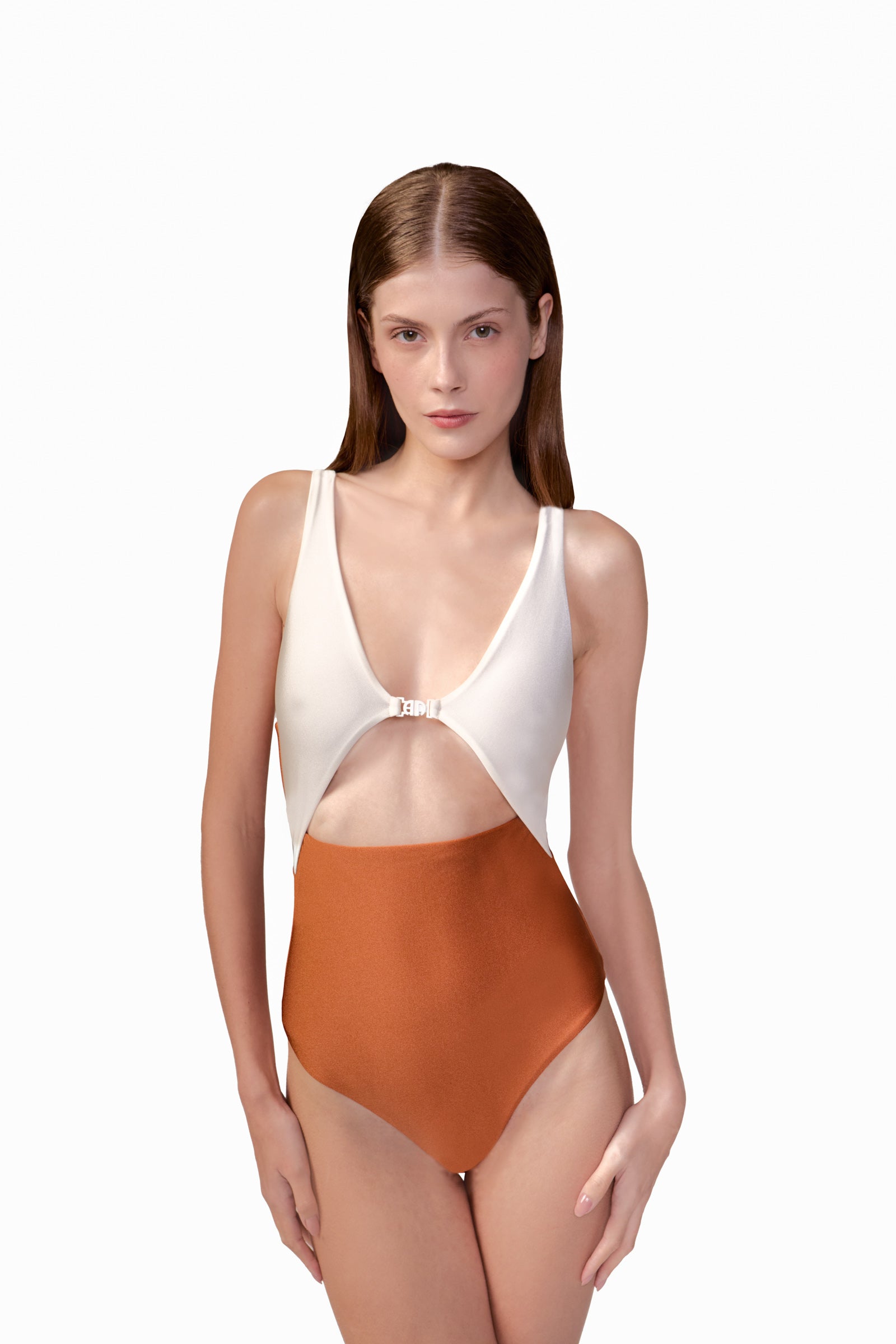Model wearing the Bicolor Cut-Out Swimsuit front color cognac, made from 85% polyamide 15% elastane, styled for a beachwear look