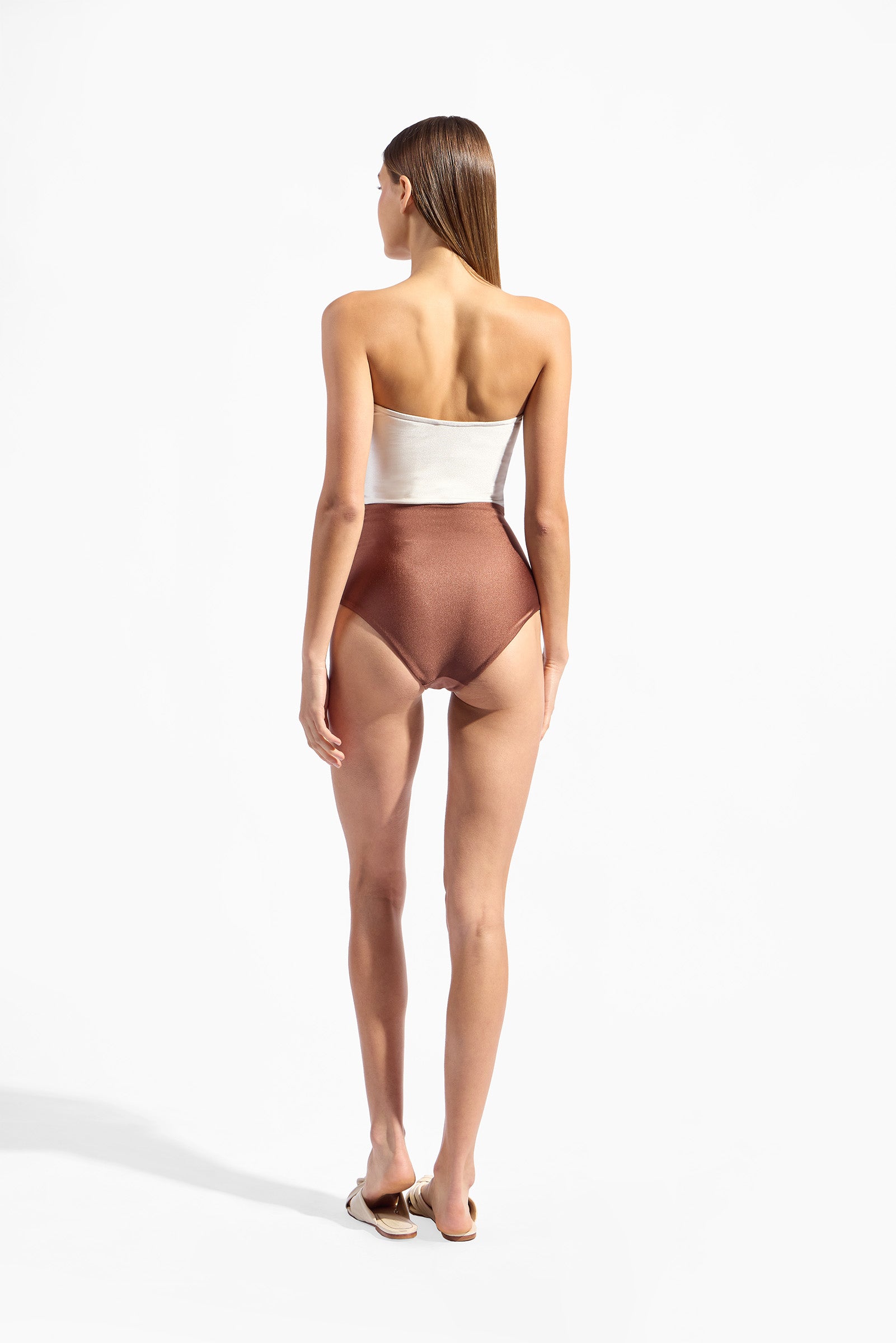 Model wearing the Bicolor Strapless Swimsuit back color cappuccino with 85% Polyamide 15% Elastane styled for a beachwear look
