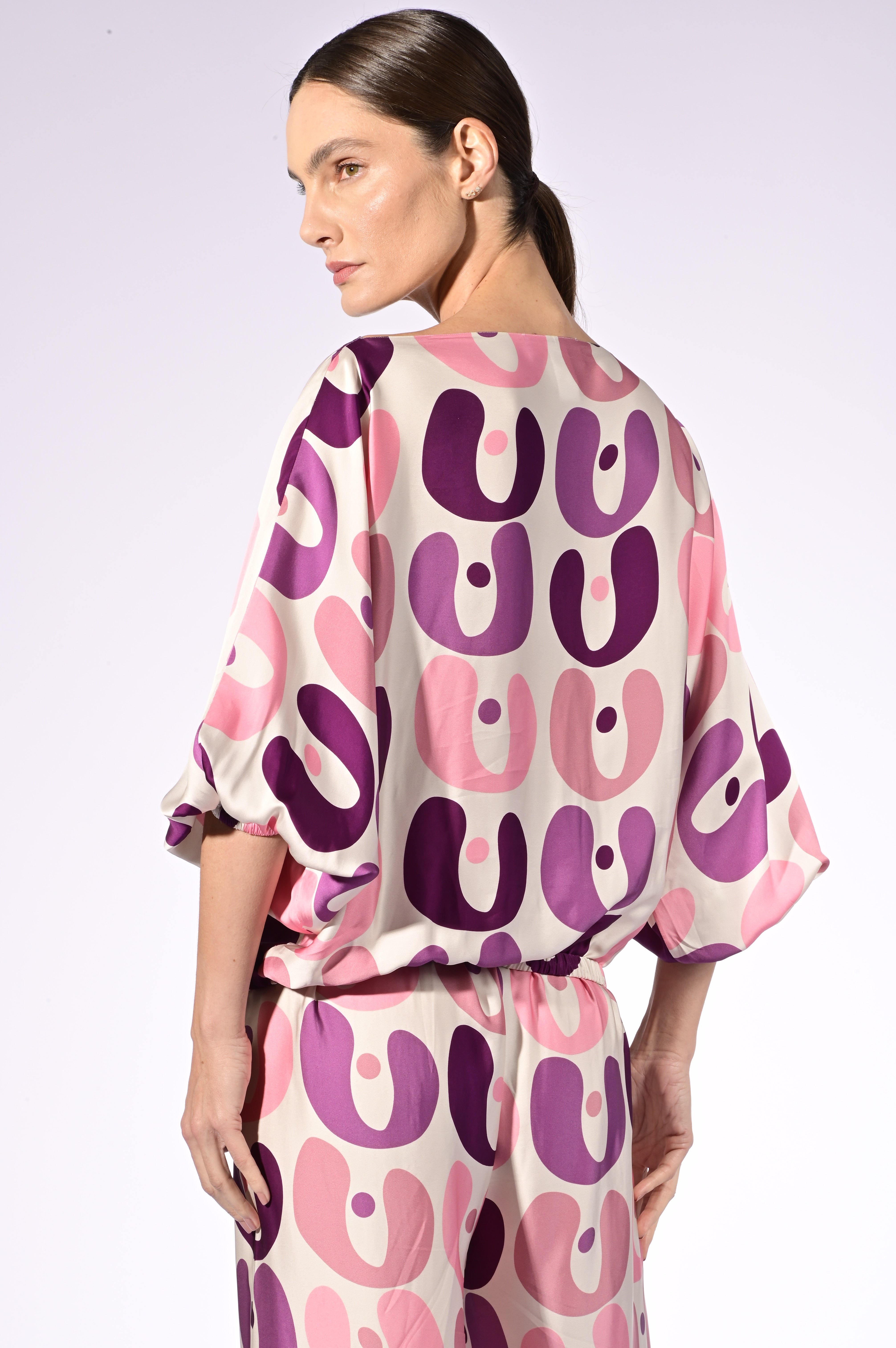 Model wearing the Bold Floral Boat Neck Blouse detail color unique, made from 100% viscose, styled for a resort look