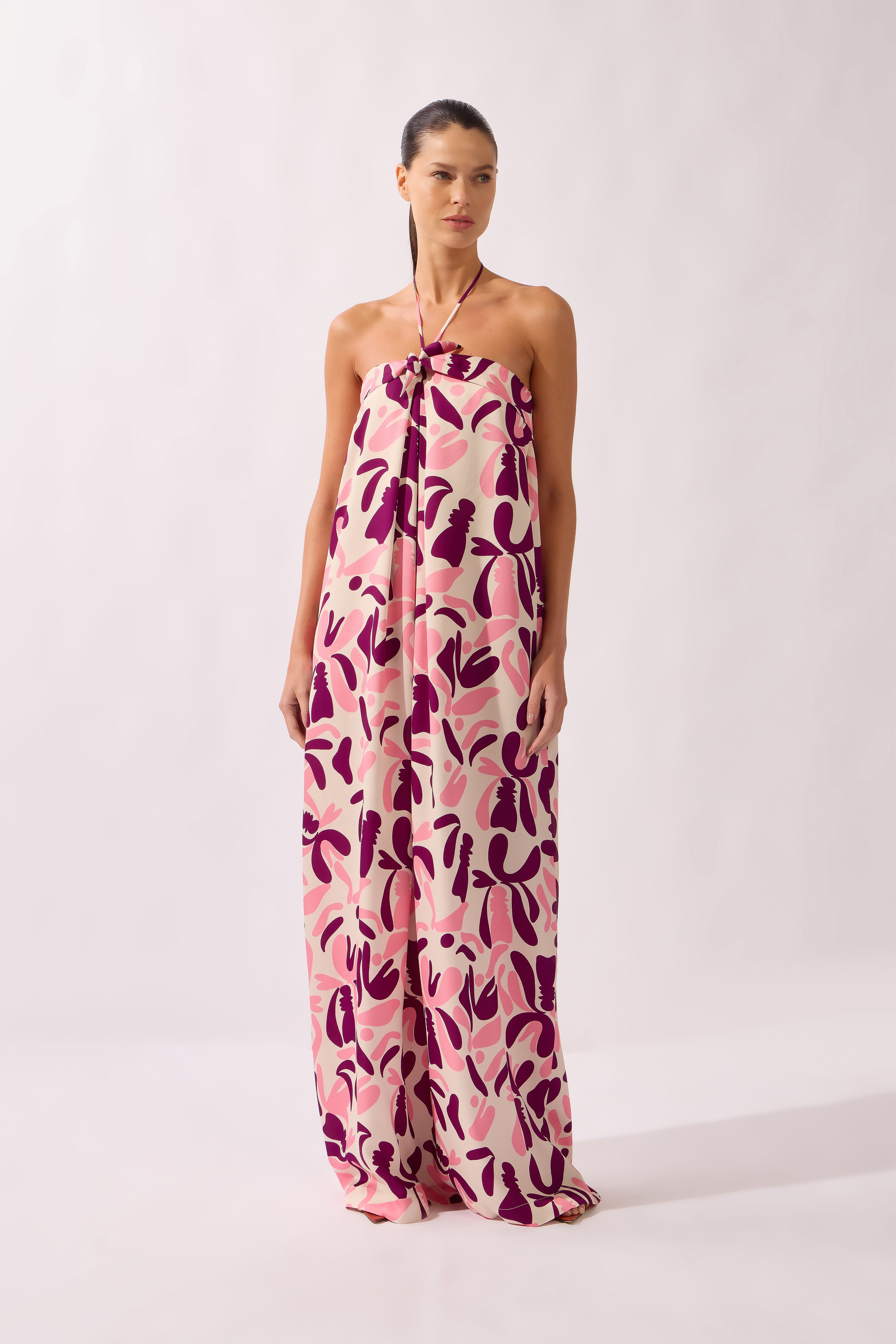 Model wearing the Bold Floral Neck-Tie Maxi Dress front unique, made from 100% viscose, styled for a beachwear look