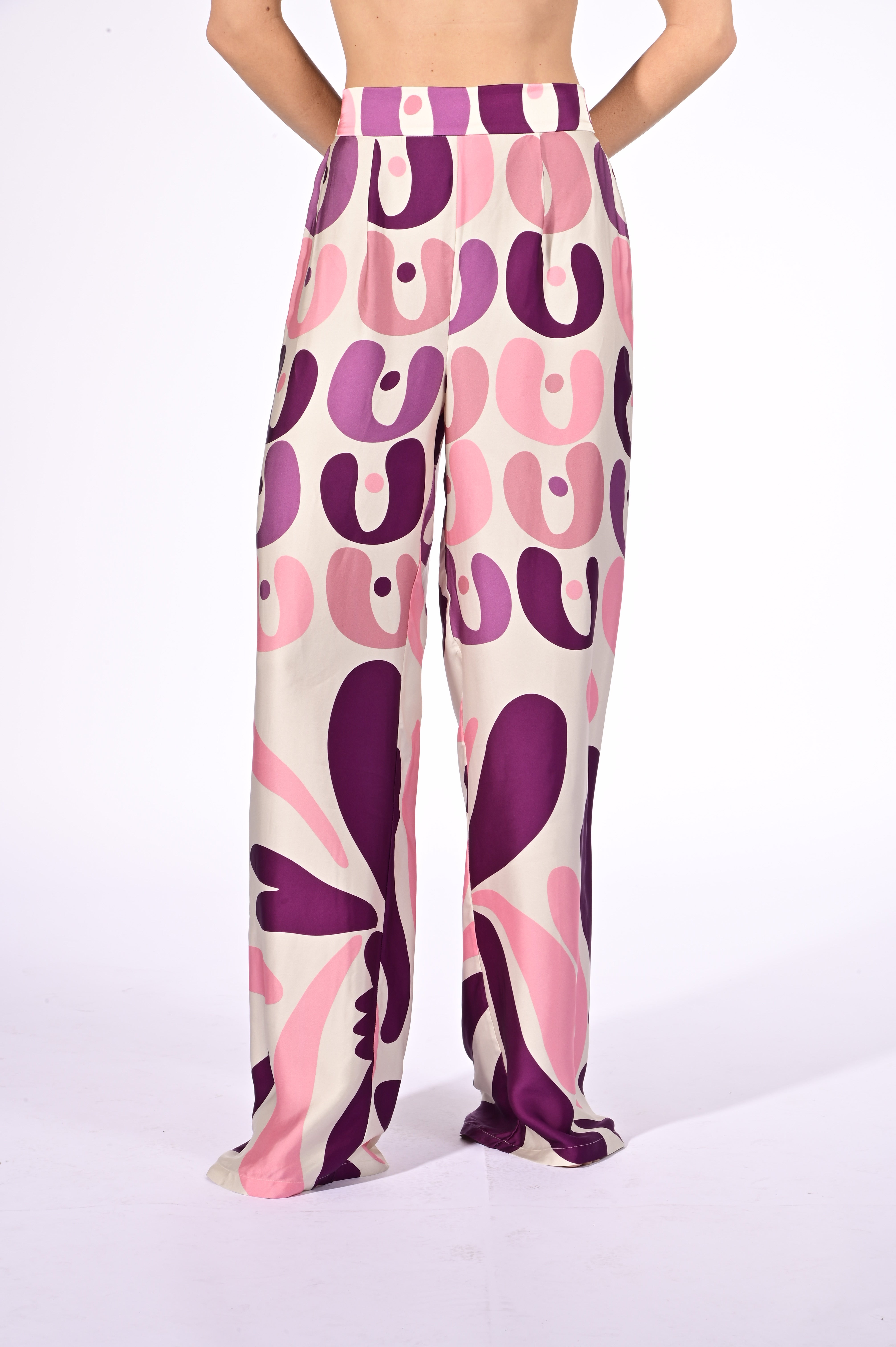 Model wearing the Bold Floral Wide-Leg Pants detail color unique, made from 100% viscose, styled for a resort look