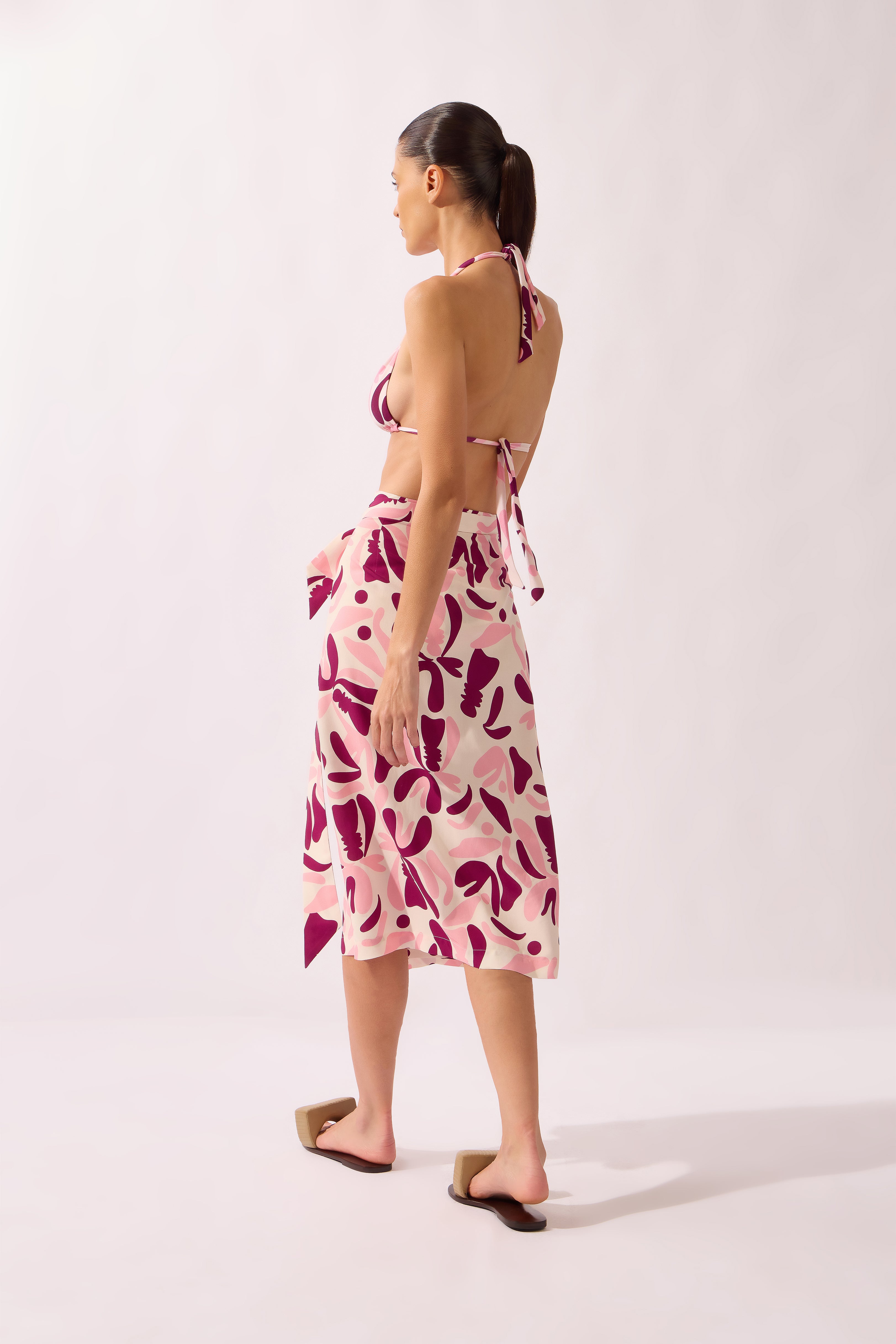 Model wearing the Bold Floral Wrap Pareo back color unique, made from 100% viscose, styled for a beachwear look