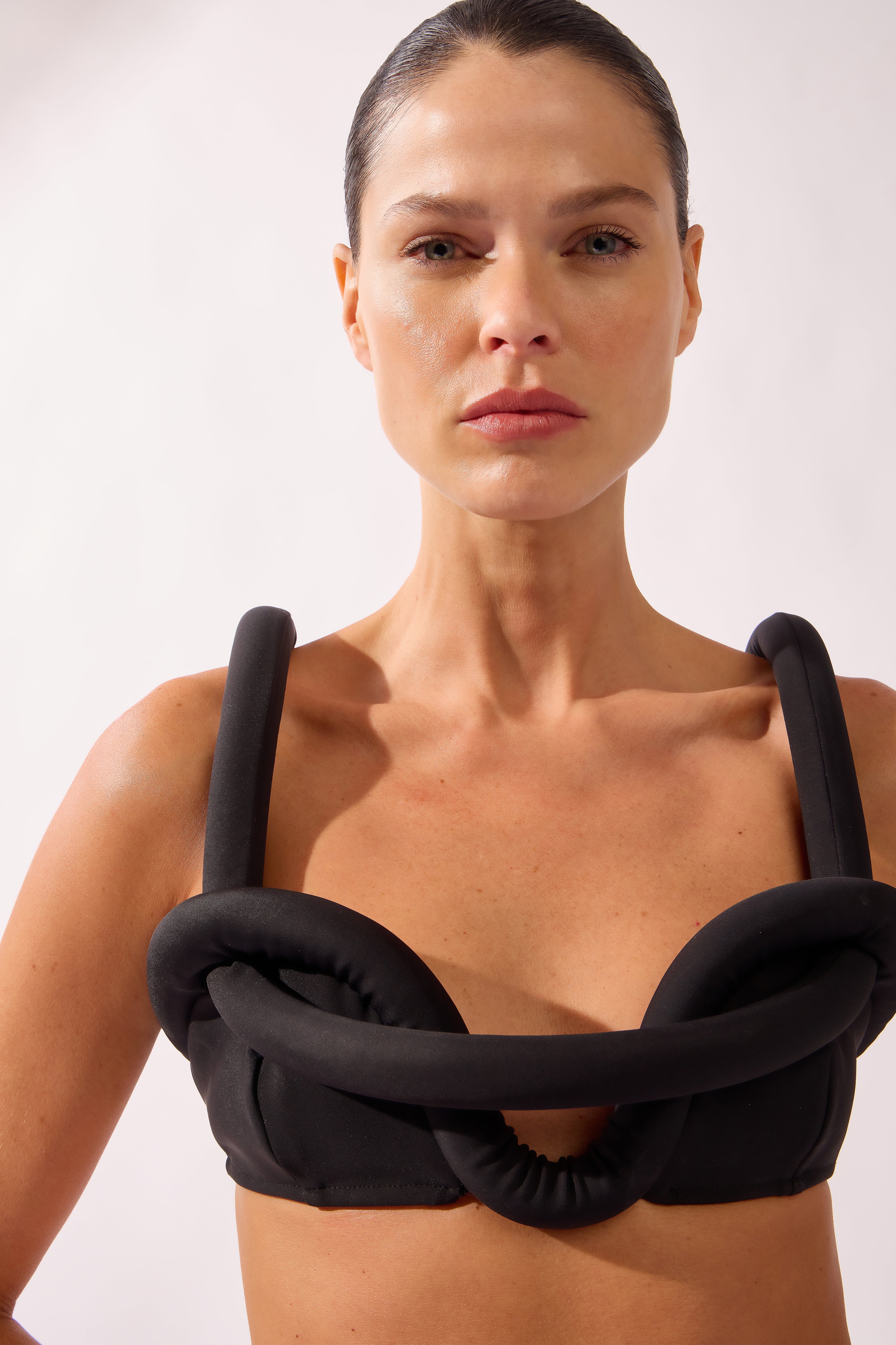 Model wearing the Bold Noir High-Leg Bikini detail top color black, made from 76.3% polyamide 23.7% elastane, styled for a beachwear look