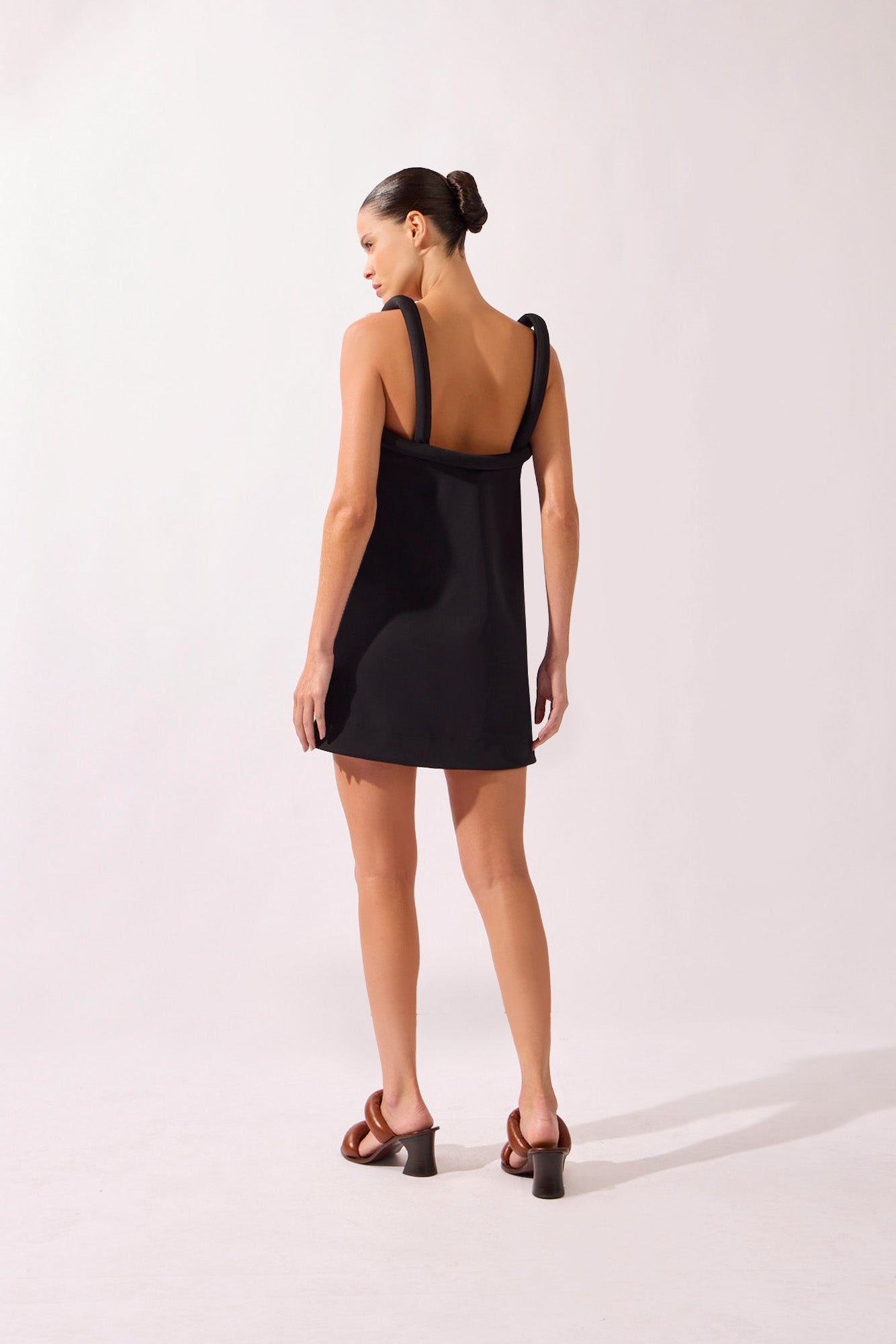 Model wearing the Solid Maxi Skirt back color off white, made from 76.3% polyamide 23.7% elastane, styled for a dinner look