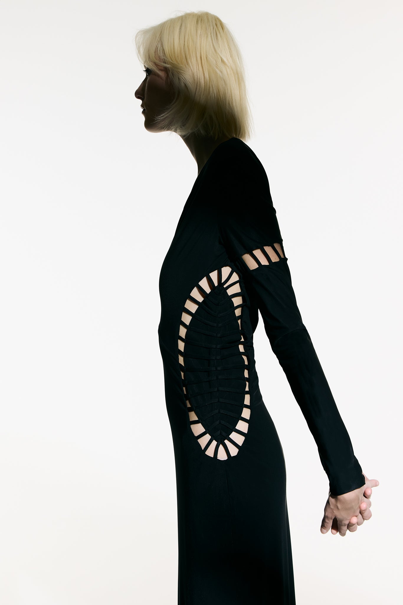 Model wearing the Cut-Out Plunge Maxi Dress detail from the Adriana Degreas and Sabine Getty collab with 75% Polyamide 25% Elastane styled for a dinner look.
