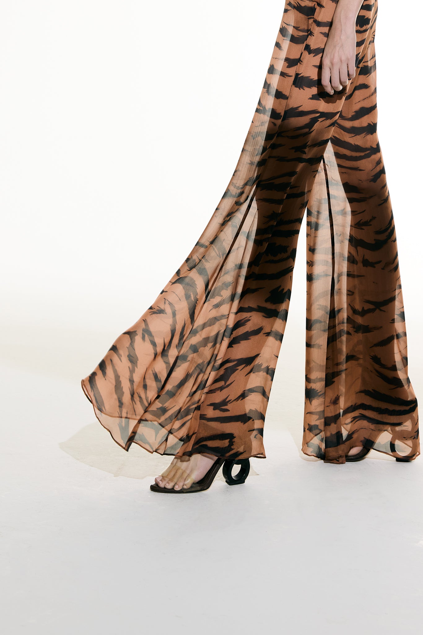 Model wearing the Flared Silk Pants detail from the Adriana Degreas and Sabine Getty collab with 100% Silk styled for a casual look.