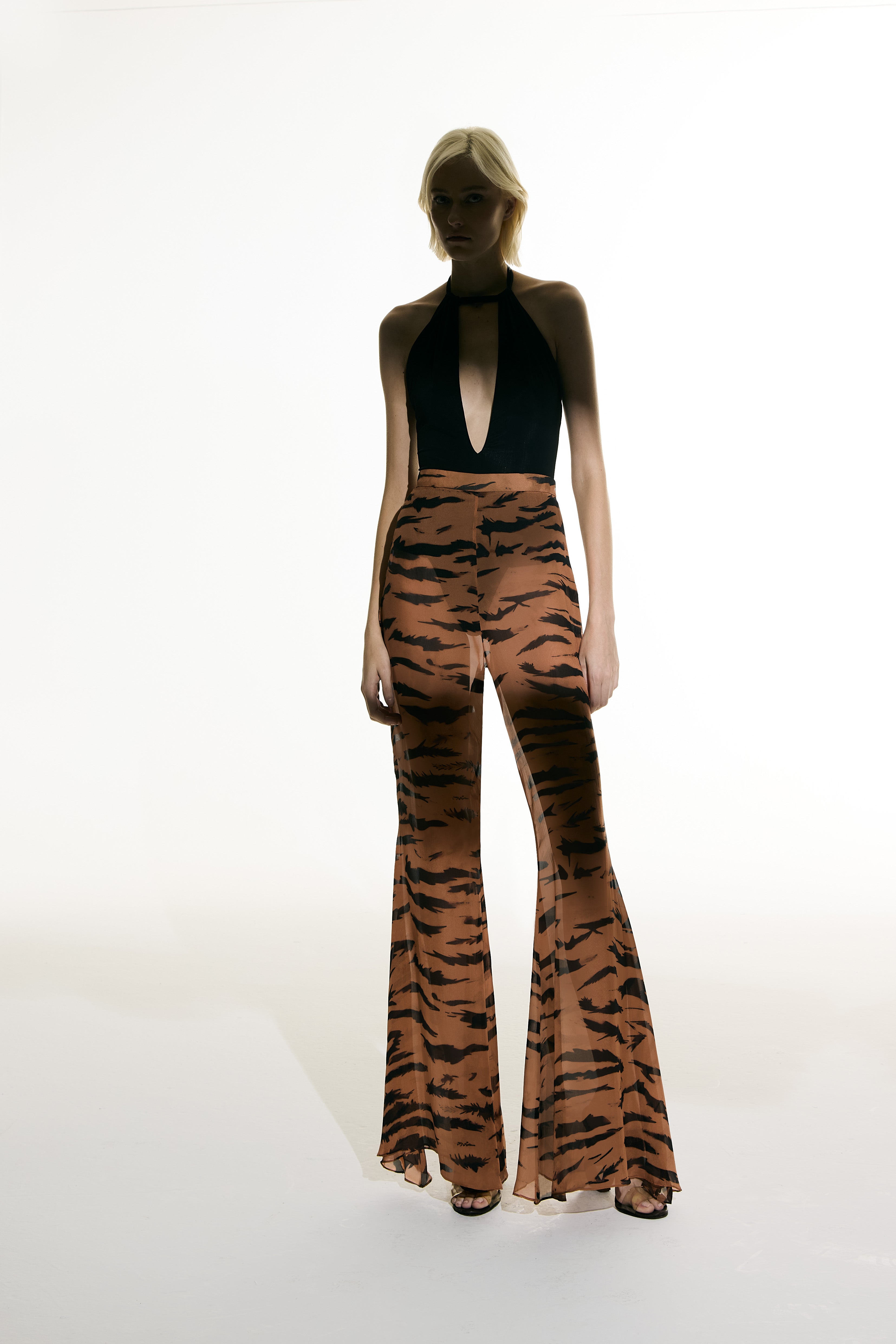 Model wearing the Flared Silk Pants front from the Adriana Degreas and Sabine Getty collab with 100% Silk styled for a casual look.