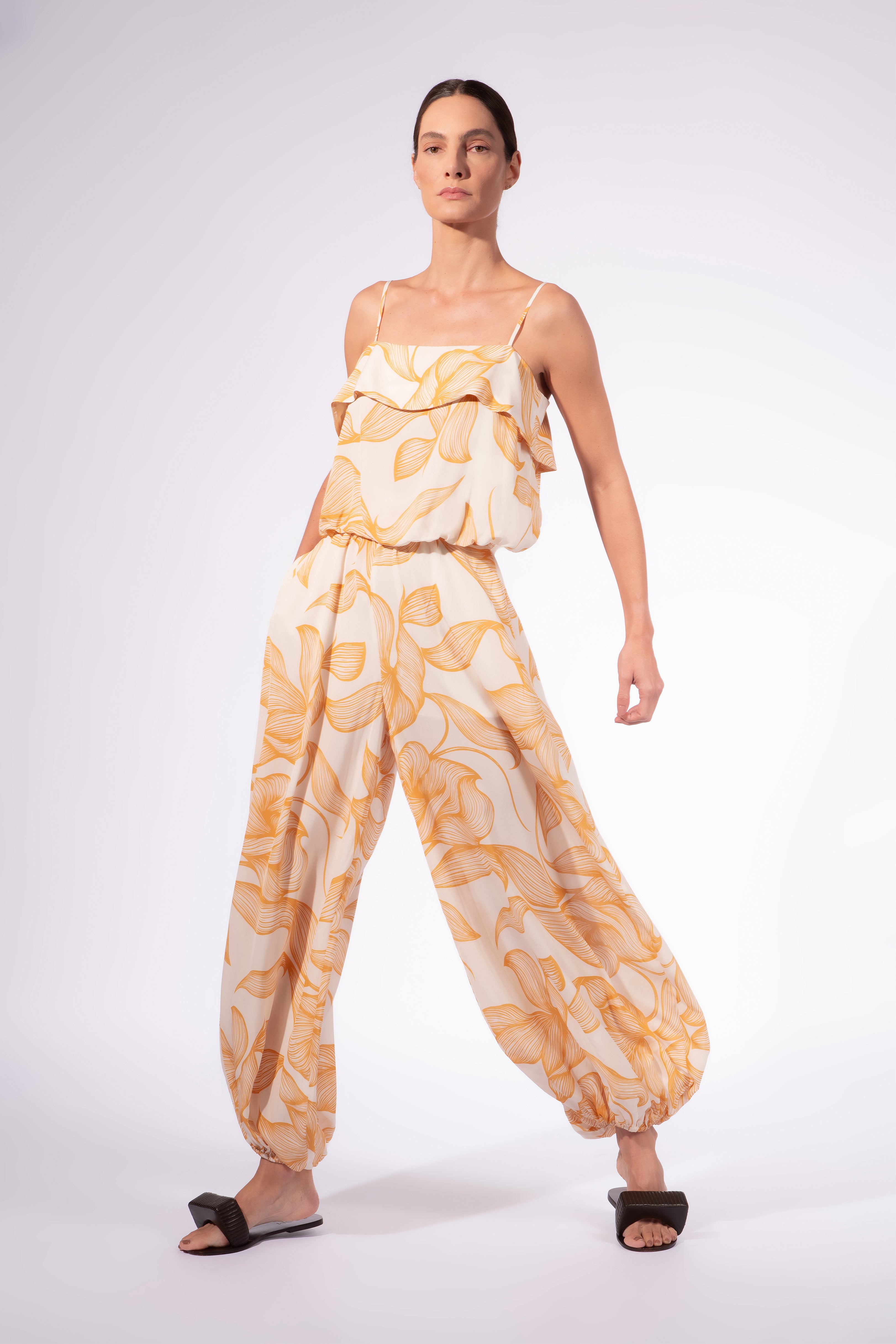Model wearing the Foliage Crop Top front color cashew yellow, made from 10% viscose, styled for a resort look