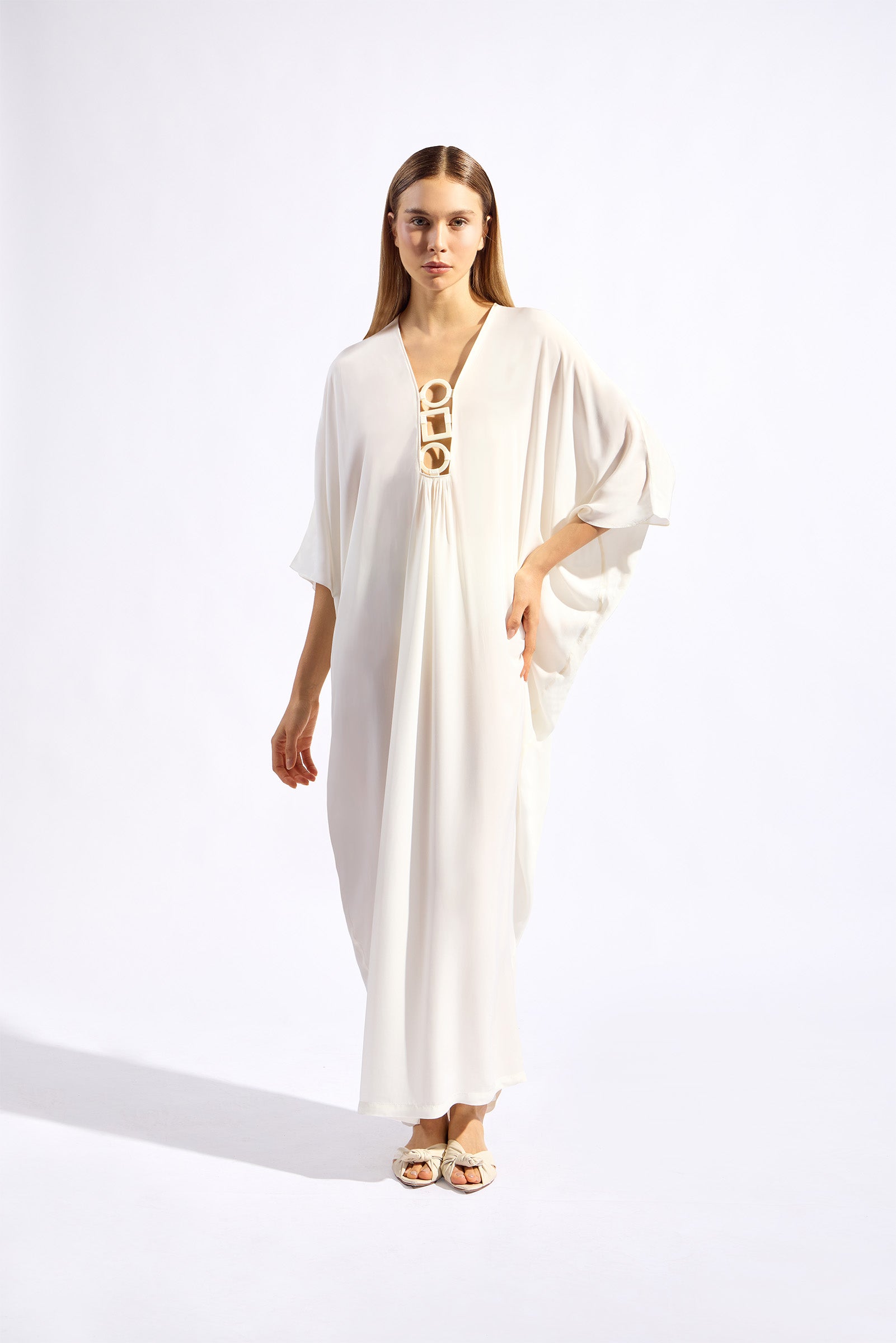 Model wearing the Geometric Long Kaftan cognac front off white from the HS25 with 100% viscose styled for a drinks by the pool look.