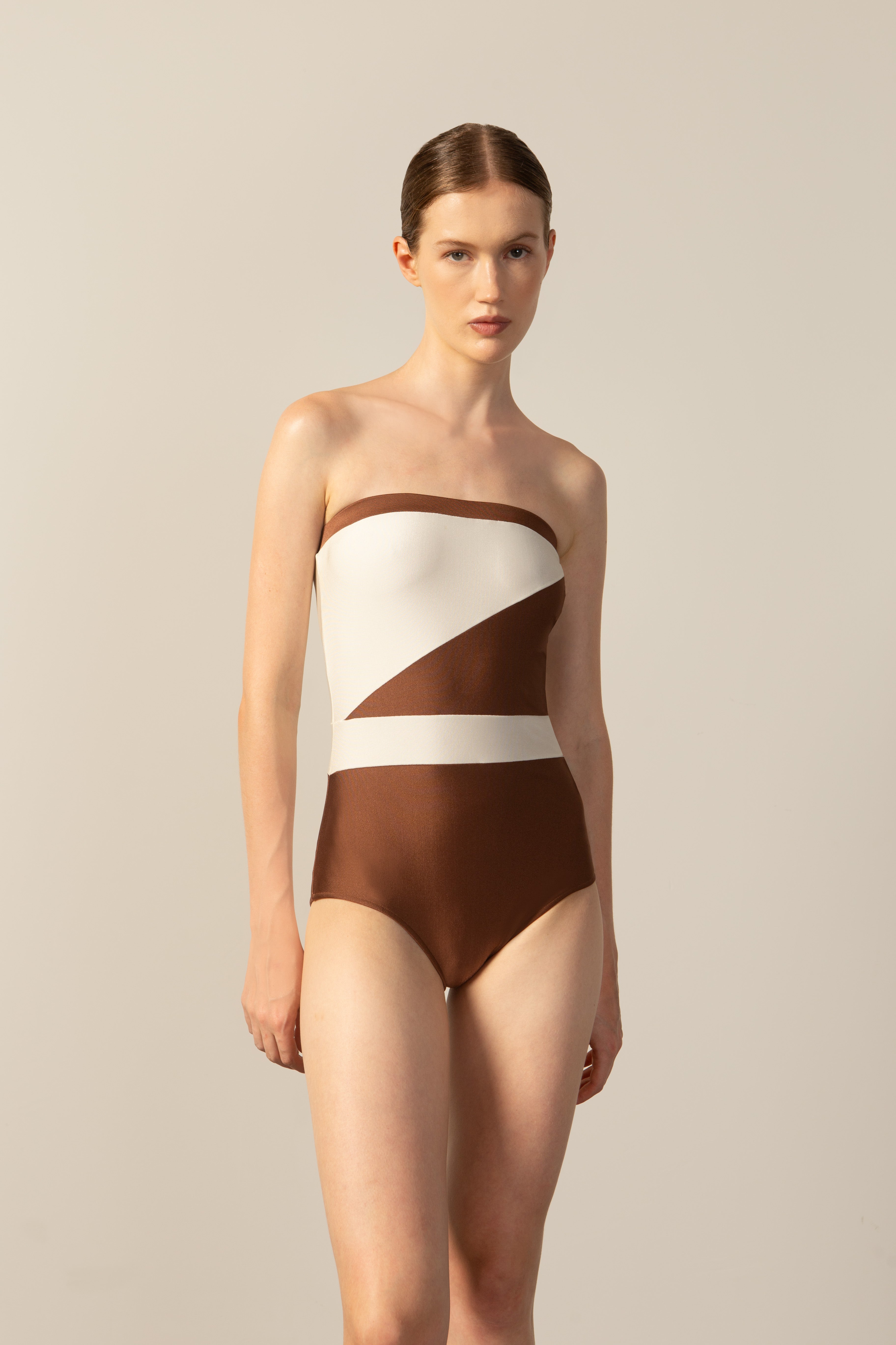 Model wearing the Geometric Strapless Swimsuit cappuccino color front from the HS25 with 85% Polyamide 15% Elastane styled for a beach look.