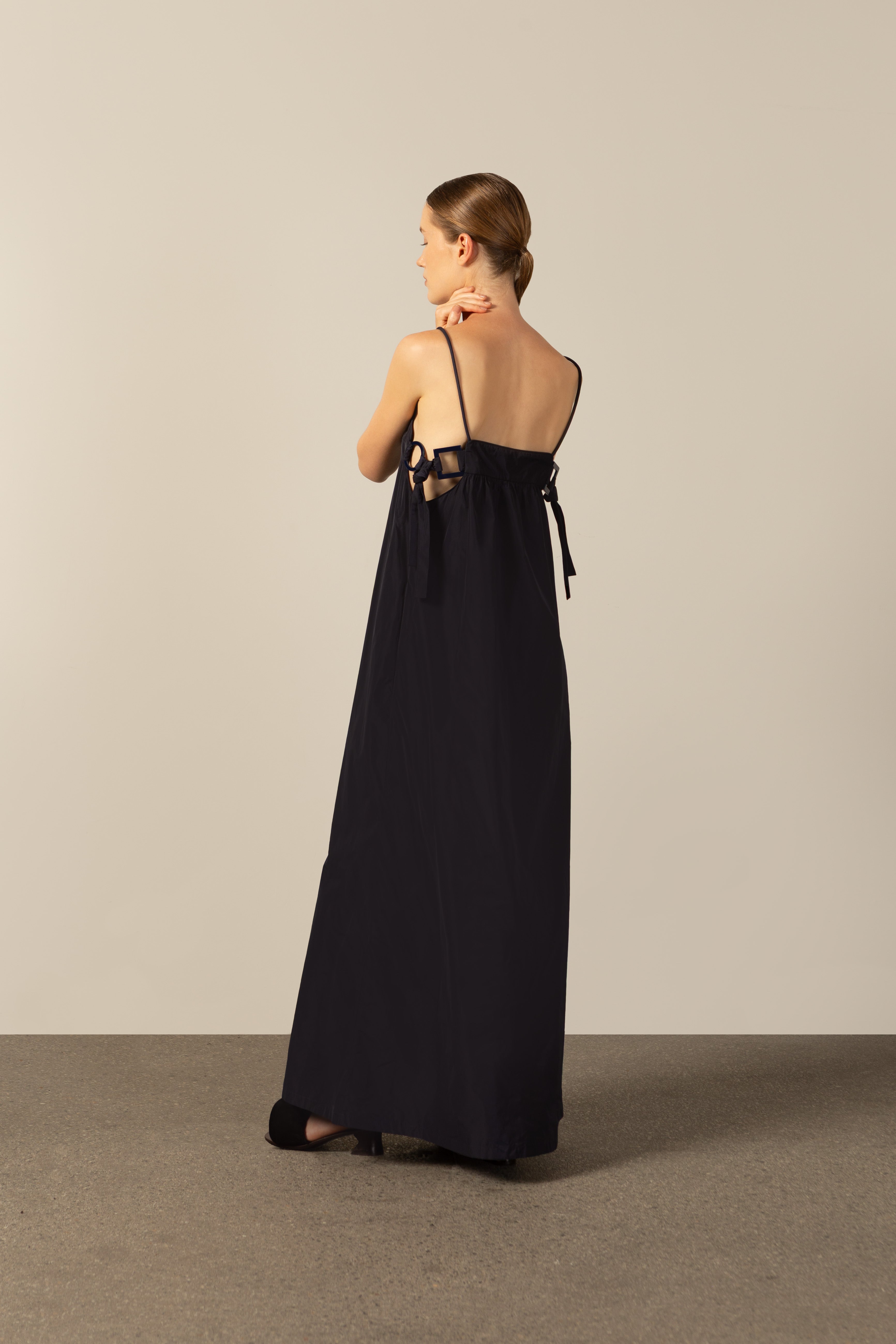 Model wearing the Geometric Straps Long Dress navy back from the HS25 with 100% polyester styled for a beach look.