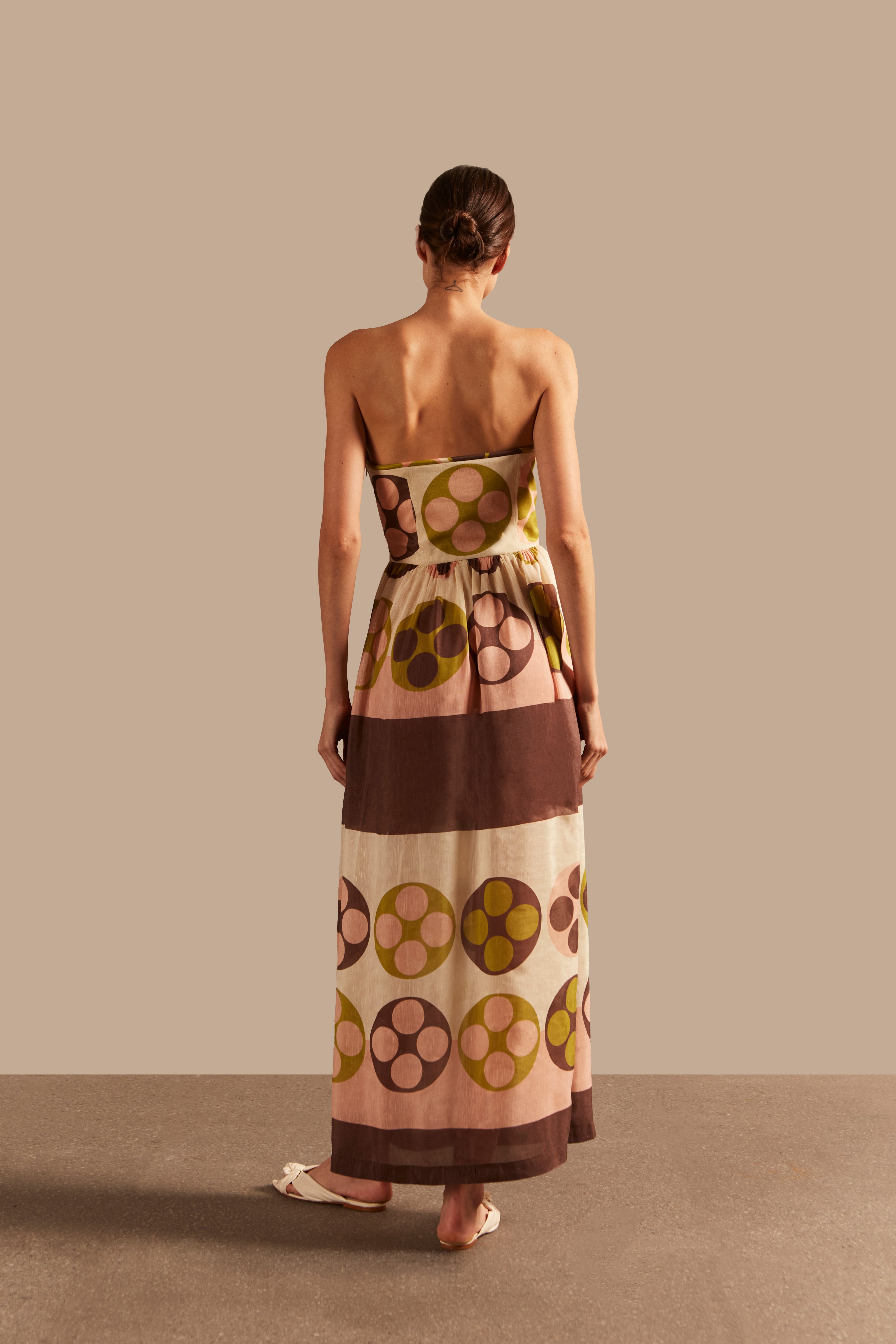 Model wearing the Giardino Strapless Long Dress Back showcasing its Unique color on 64% Linen 36% Silk fabric, styled for an afternoon look.