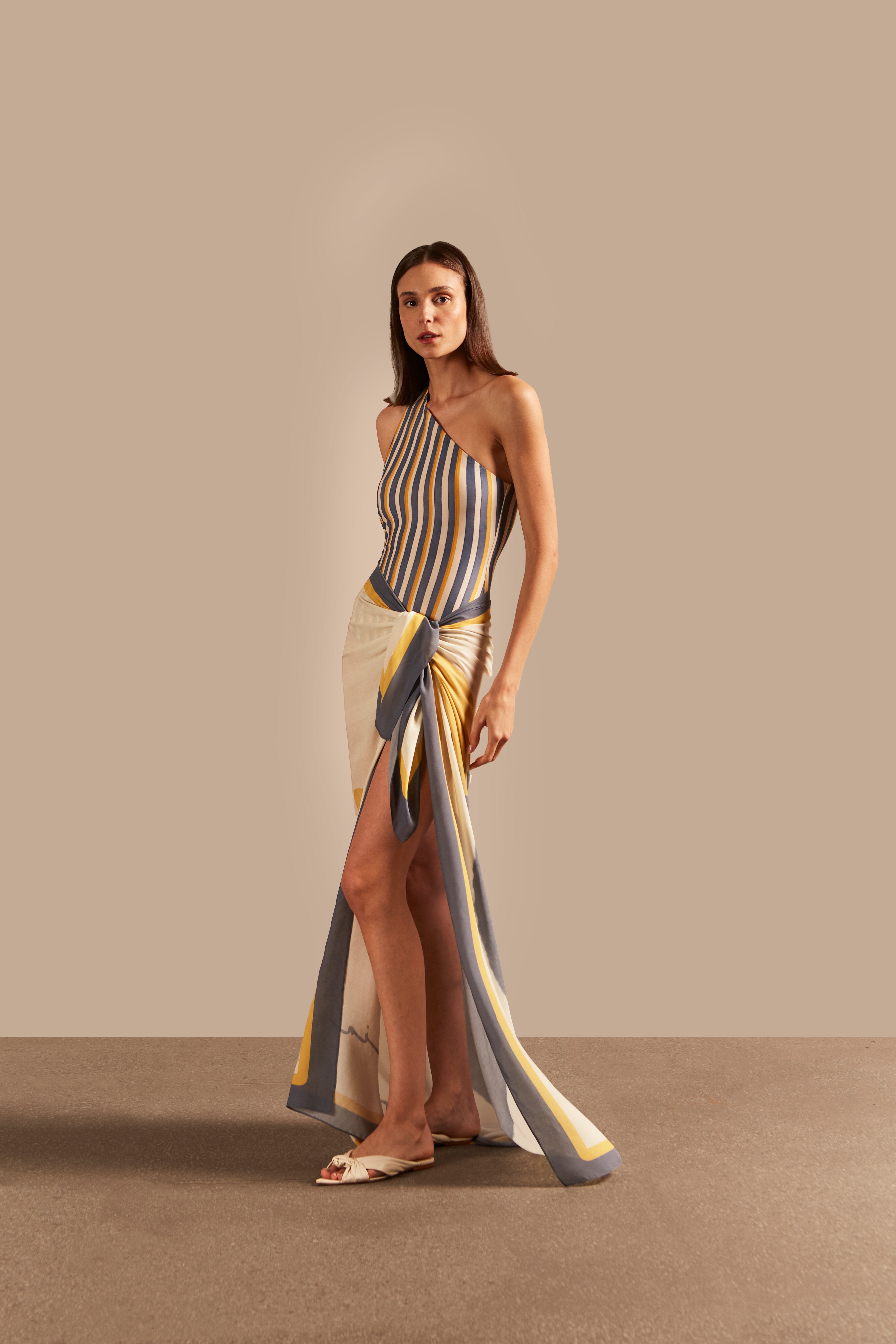 Side view of the Golden Age One-Shoulder Swimsuit showcasing its striped pattern in blue, off-white, and yellow with an elegant one-shoulder design.