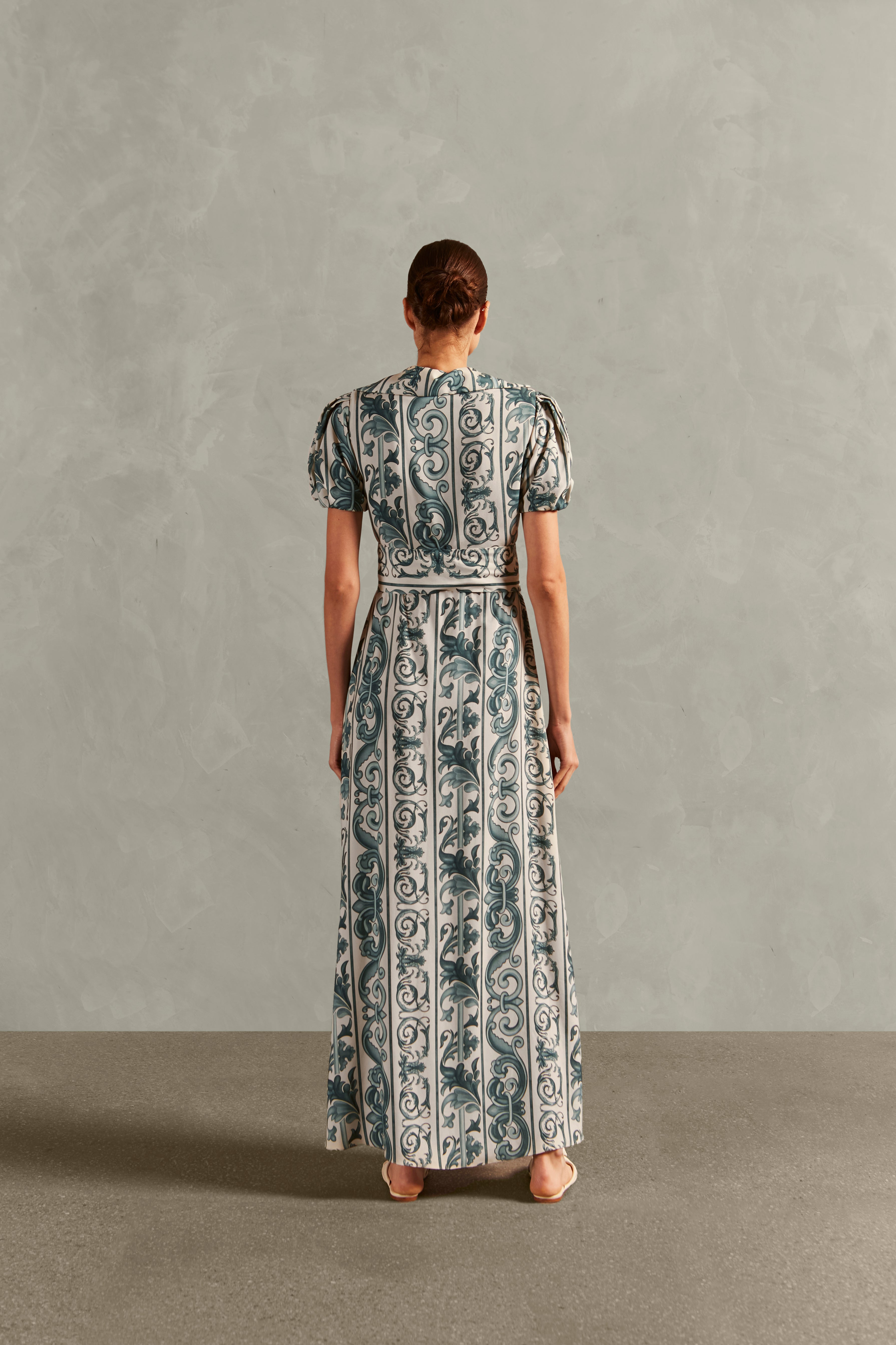 Model wearing the Hera Puff-Sleeved Long Dress Back showcasing its BLUE color on 100% Viscose fabric, styled for a resort look.