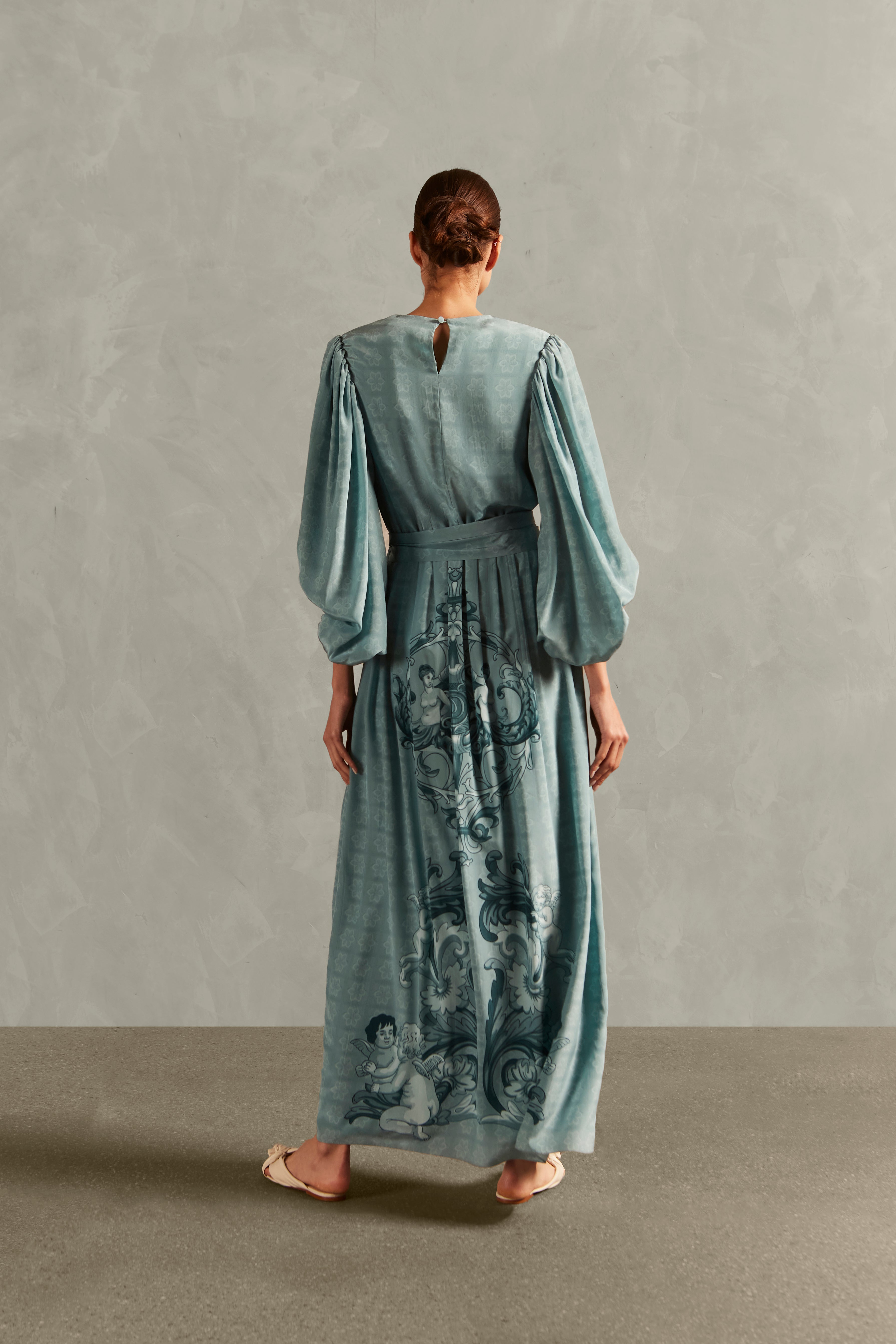 Model wearing the Hera Puff-Sleeved Long Dress Back showcasing its Blue color on 100% Silk fabric.
