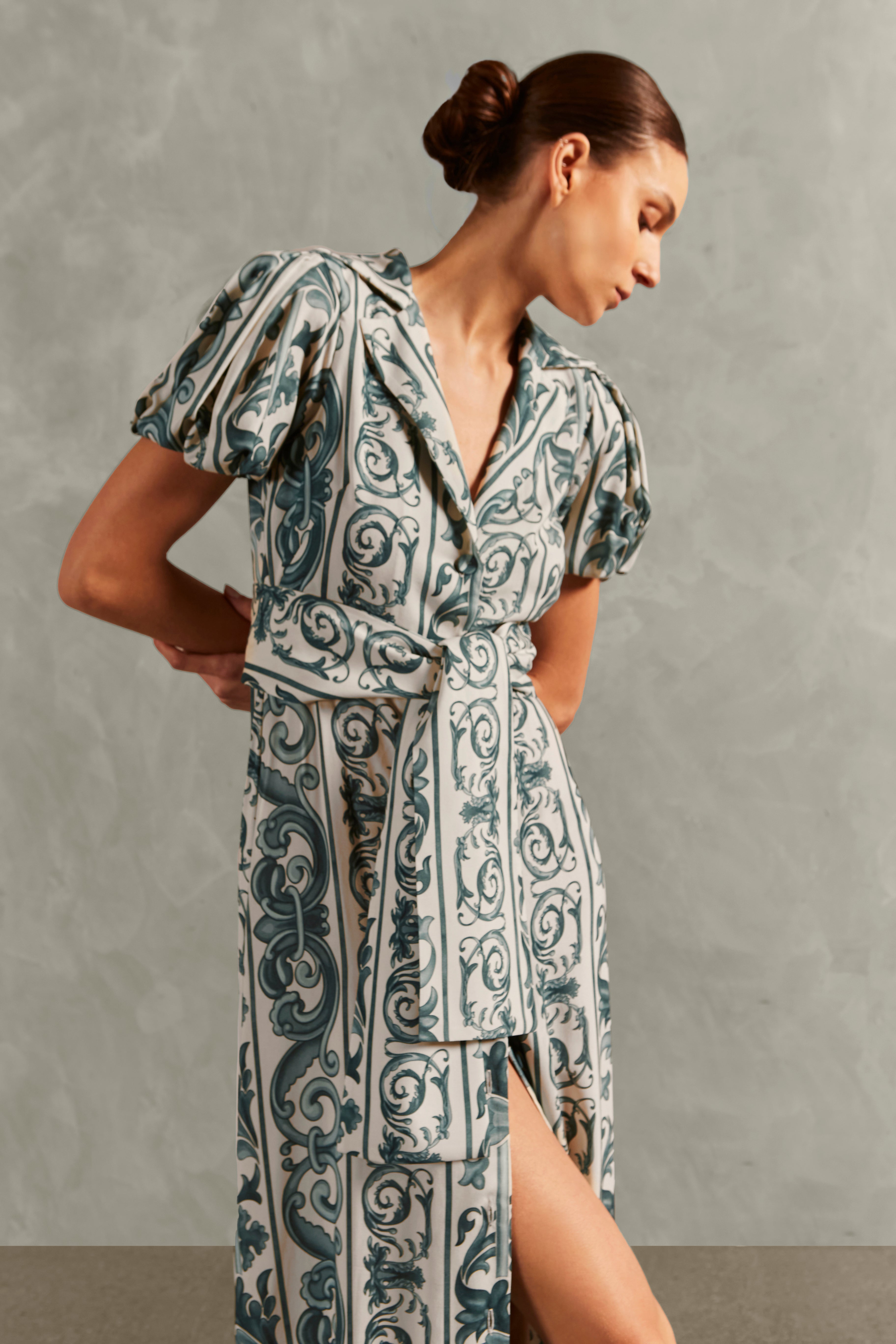 Model wearing the Hera Puff-Sleeved Long Dress Detail showcasing its BLUE color on 100% Viscose fabric, styled for a resort look.