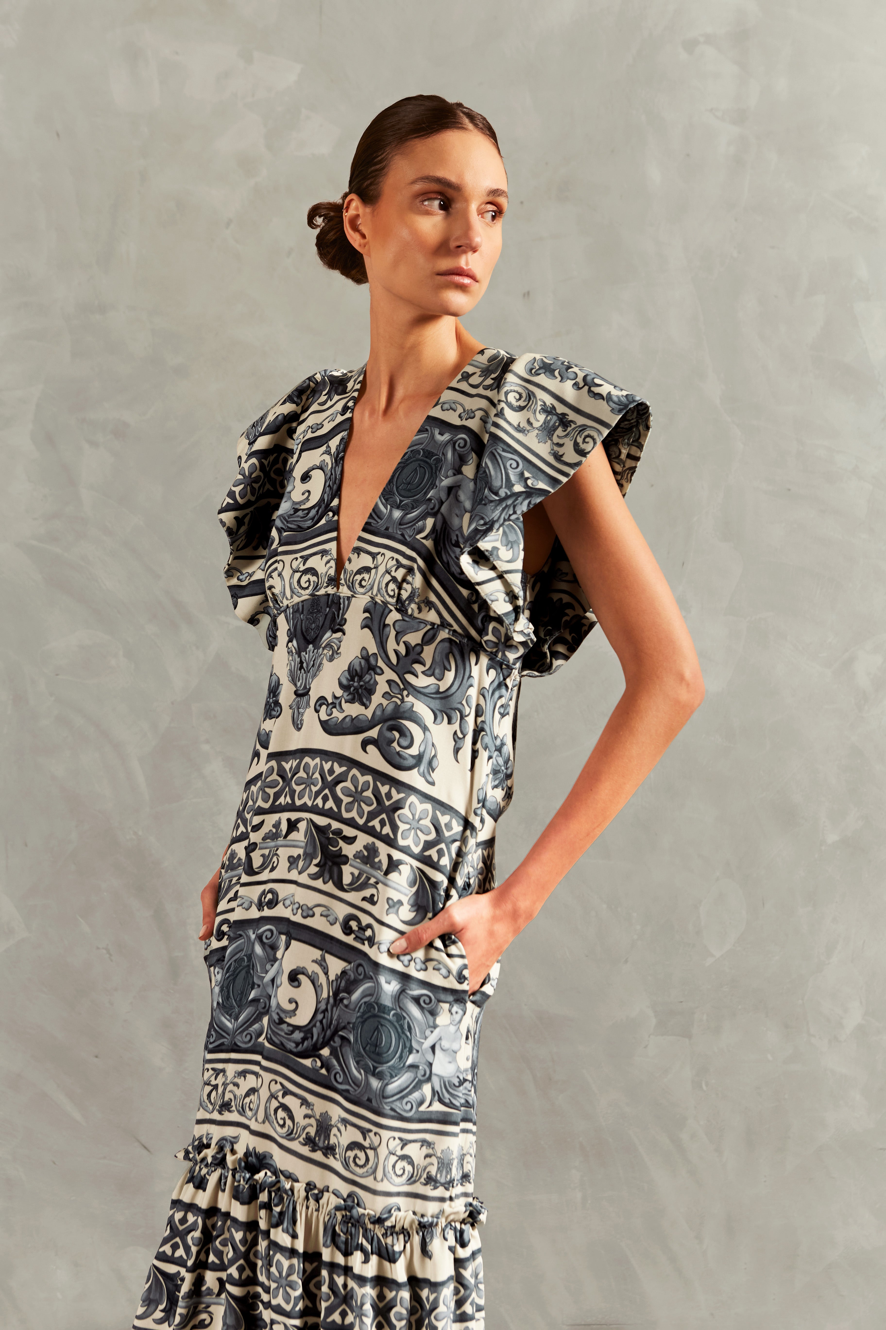 Model wearing the Hera Ruffled Long Dress color blue detail, with 100% viscose fabric, styled for a resort look