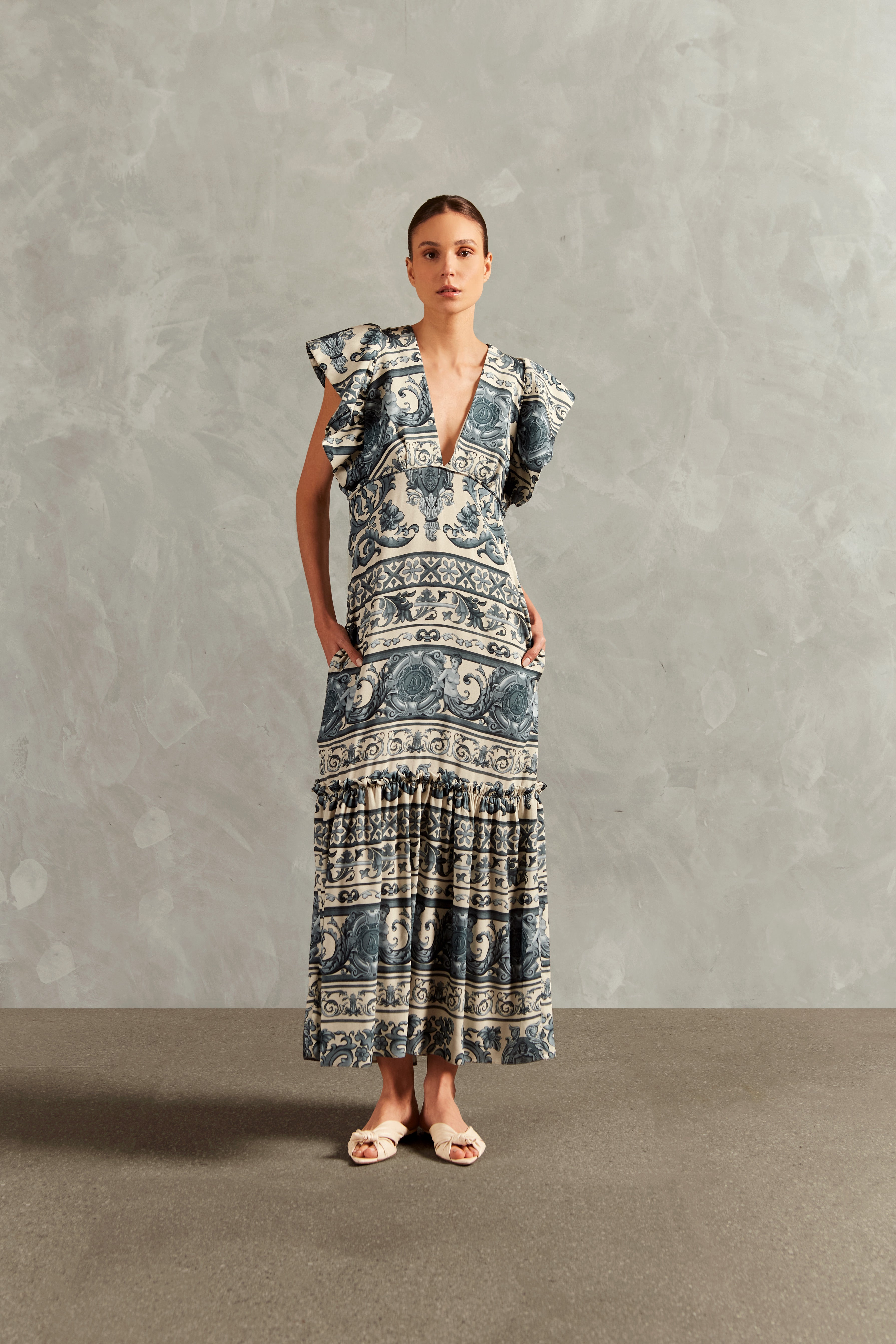 Model wearing the Hera Ruffled Long Dress color blue with 100% viscose fabric, styled for a resort look