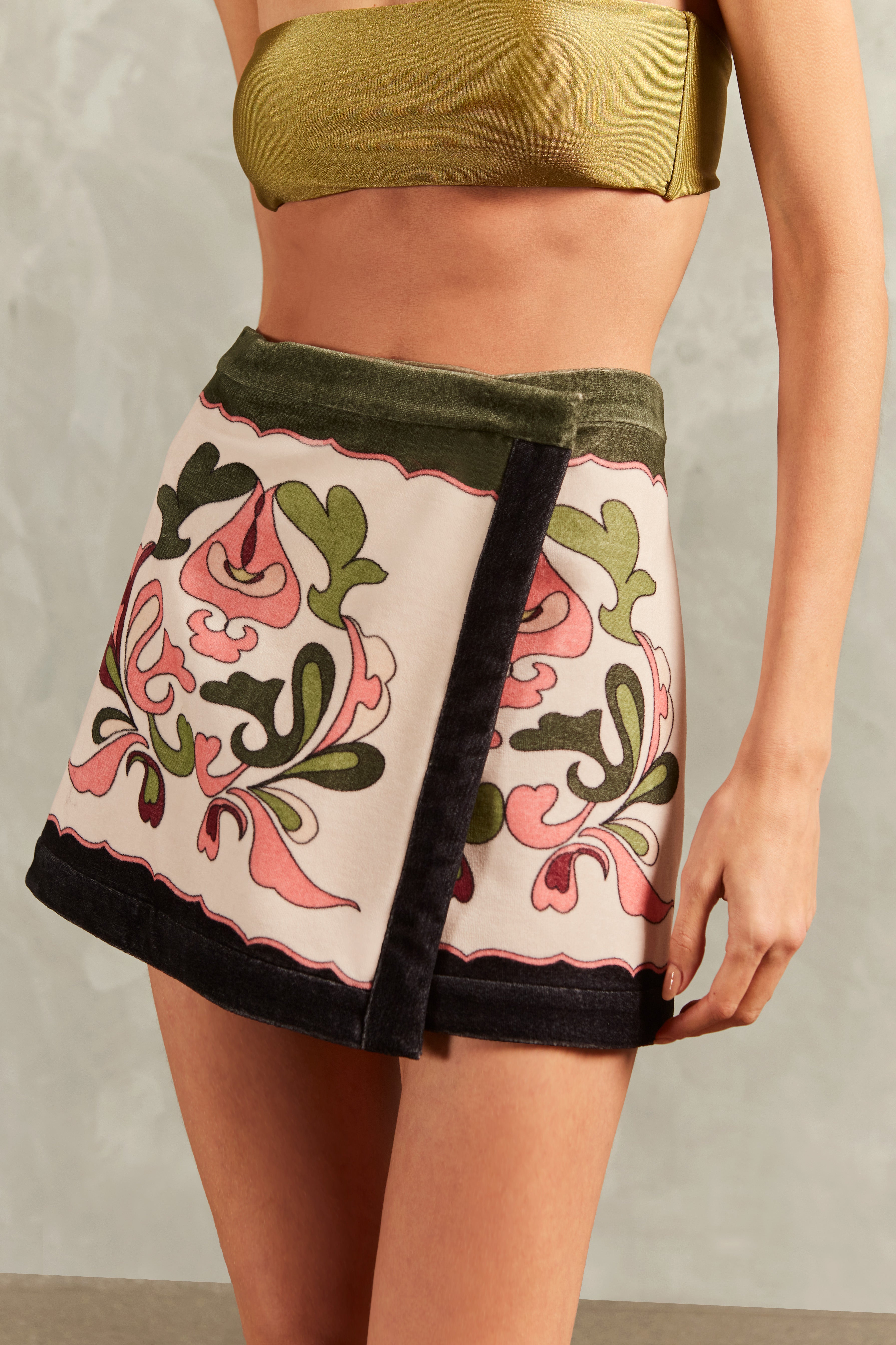 Model wearing the Inamorata Mini Skirt Detail showcasing its Off White color on 80% Cotton 20% Polyester fabric, styled for an post-beach look.