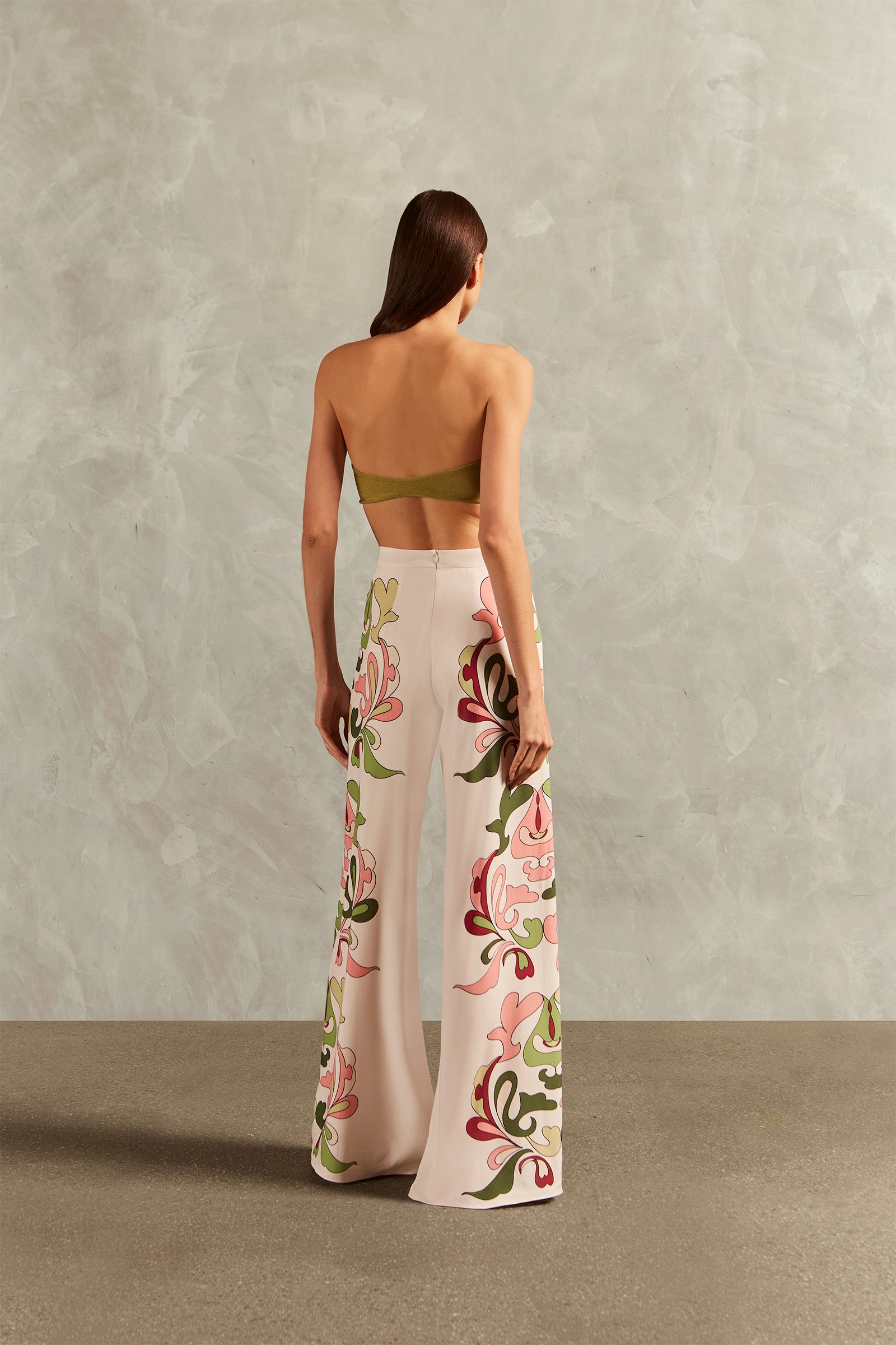 Model wearing the Inamorata Wide-Leg Pants Back showcasing its Off White color on 100% Viscose fabric, styled for an post-beach look.