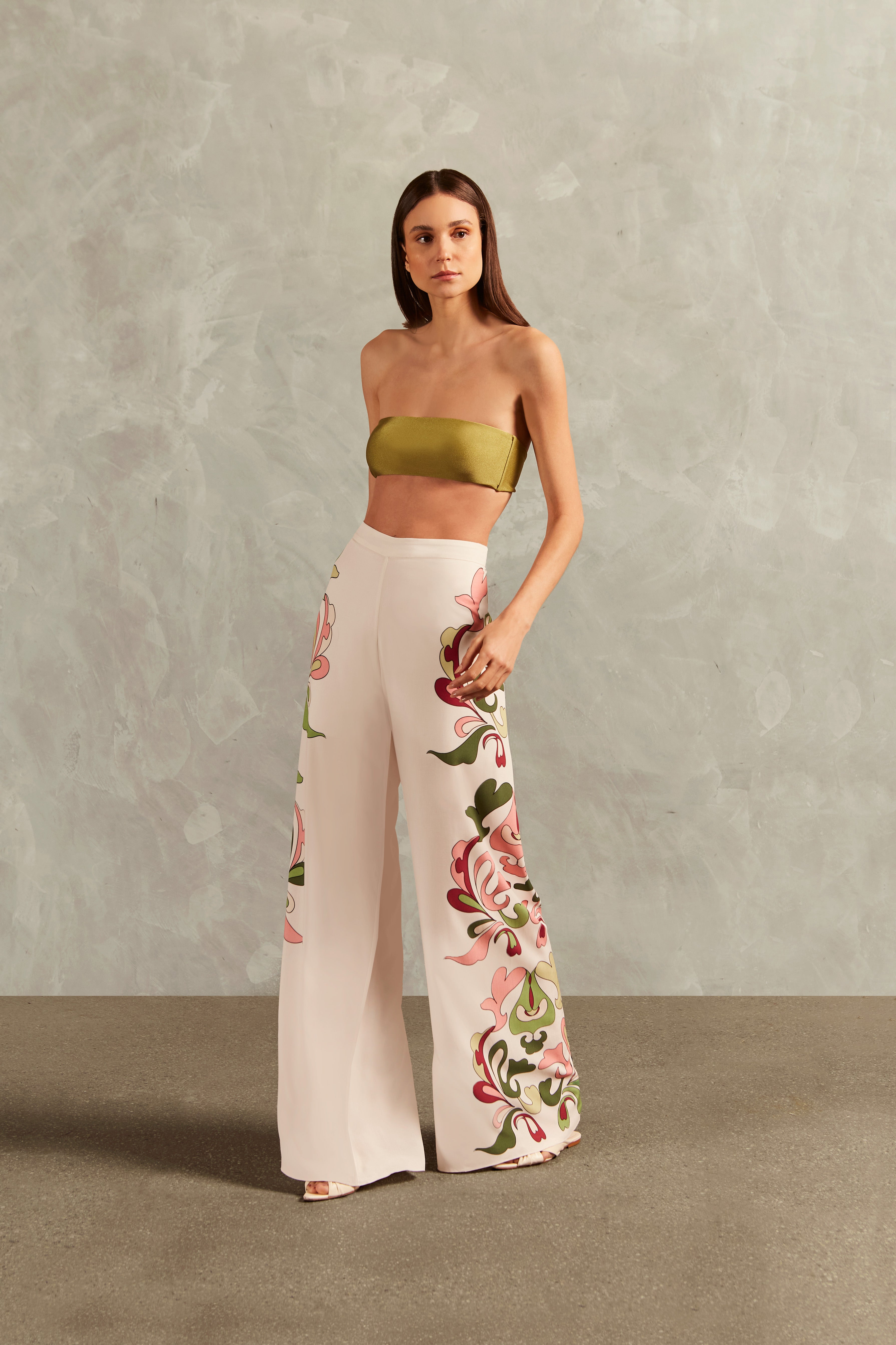 Model wearing the Inamorata Wide-Leg Pants Front showcasing its Off White color on 100% Viscose fabric, styled for an post-beach look.