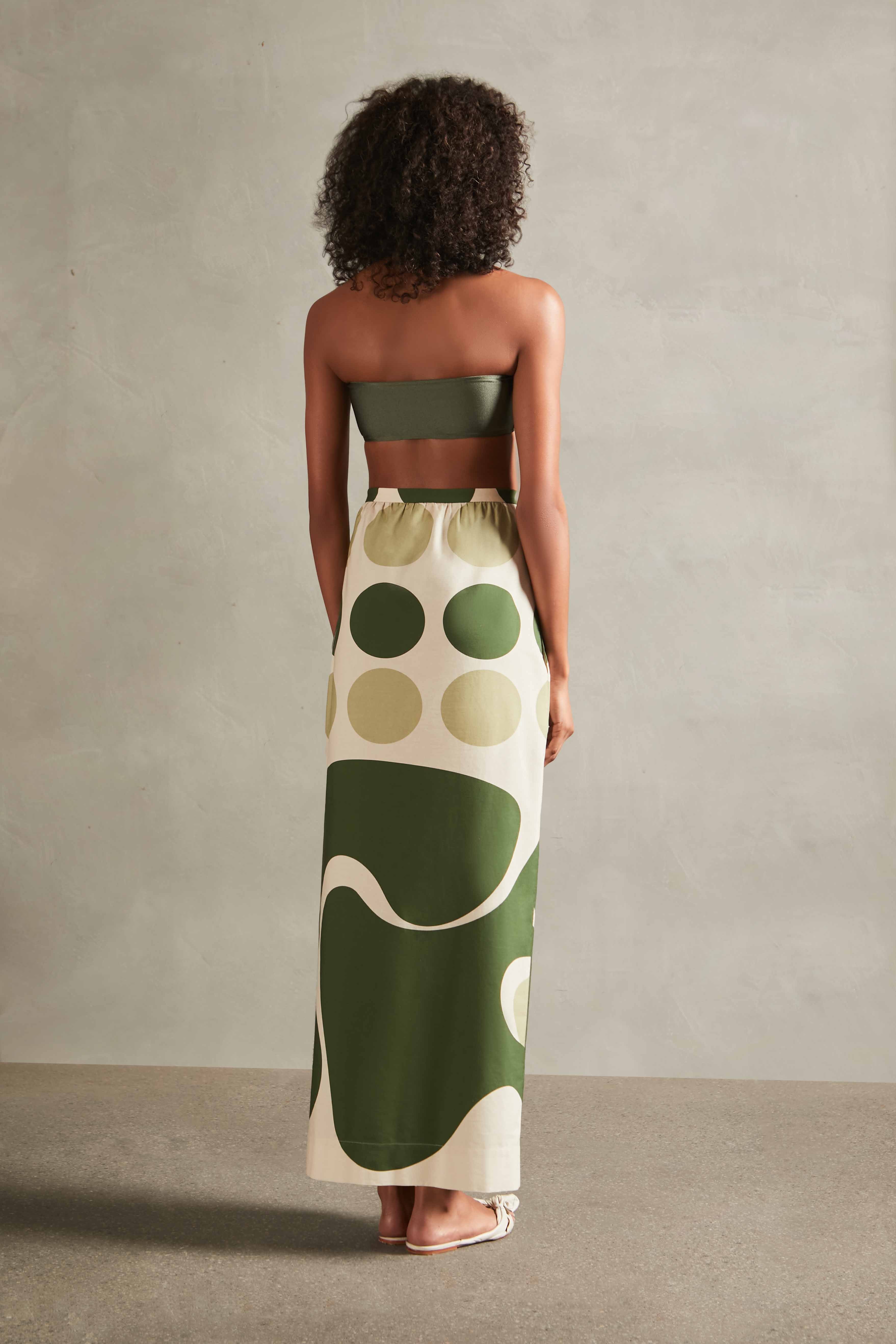 Model wearing the Jellyfish Long Skirt Back with bikini top with unique Print on 97% Polyester 3% Elastane, styled for a resort look.