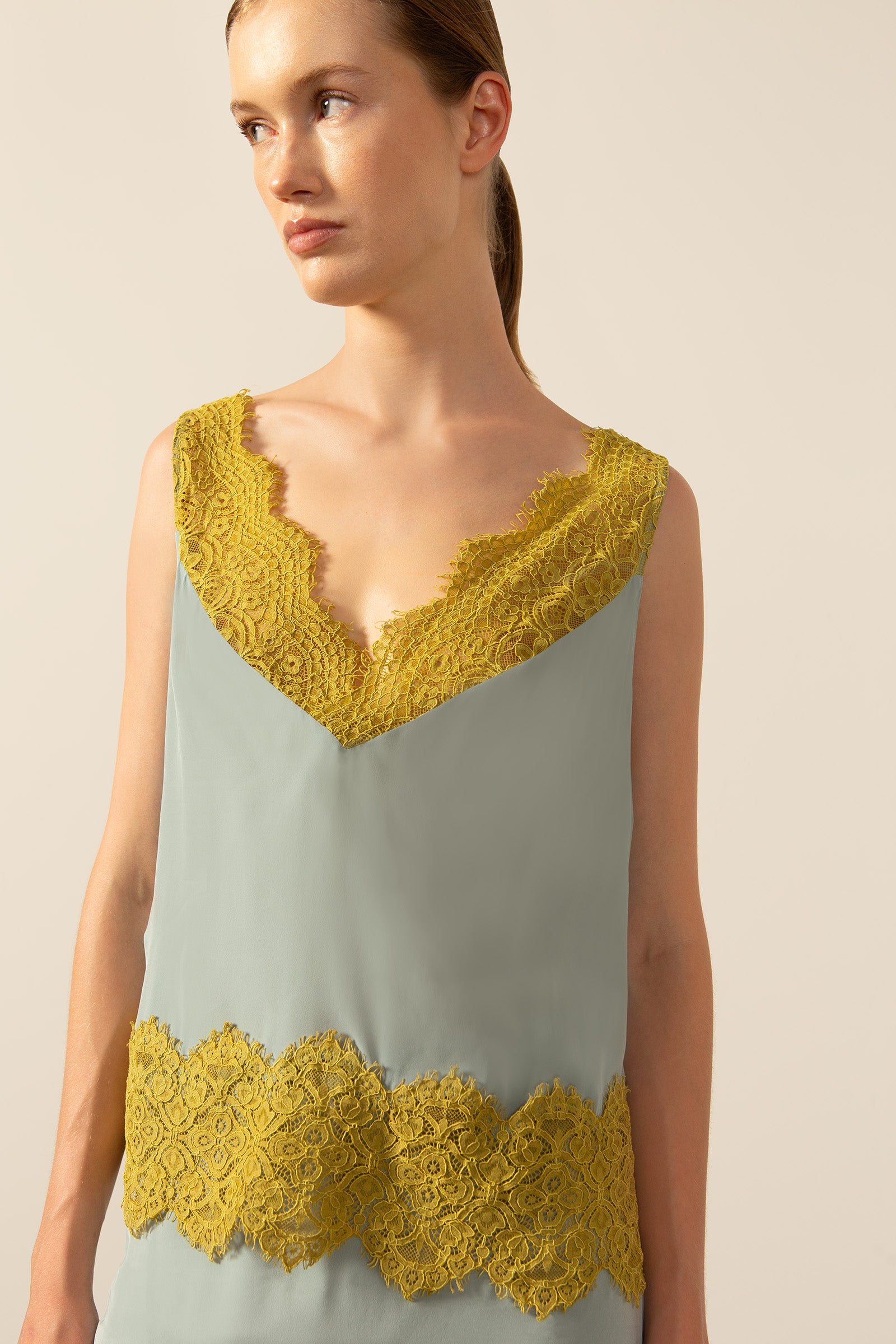 Model wearing La Sirenuse Lace V-Neck Tank Top detail color blue, made from 100% viscose, styled for a resort look
