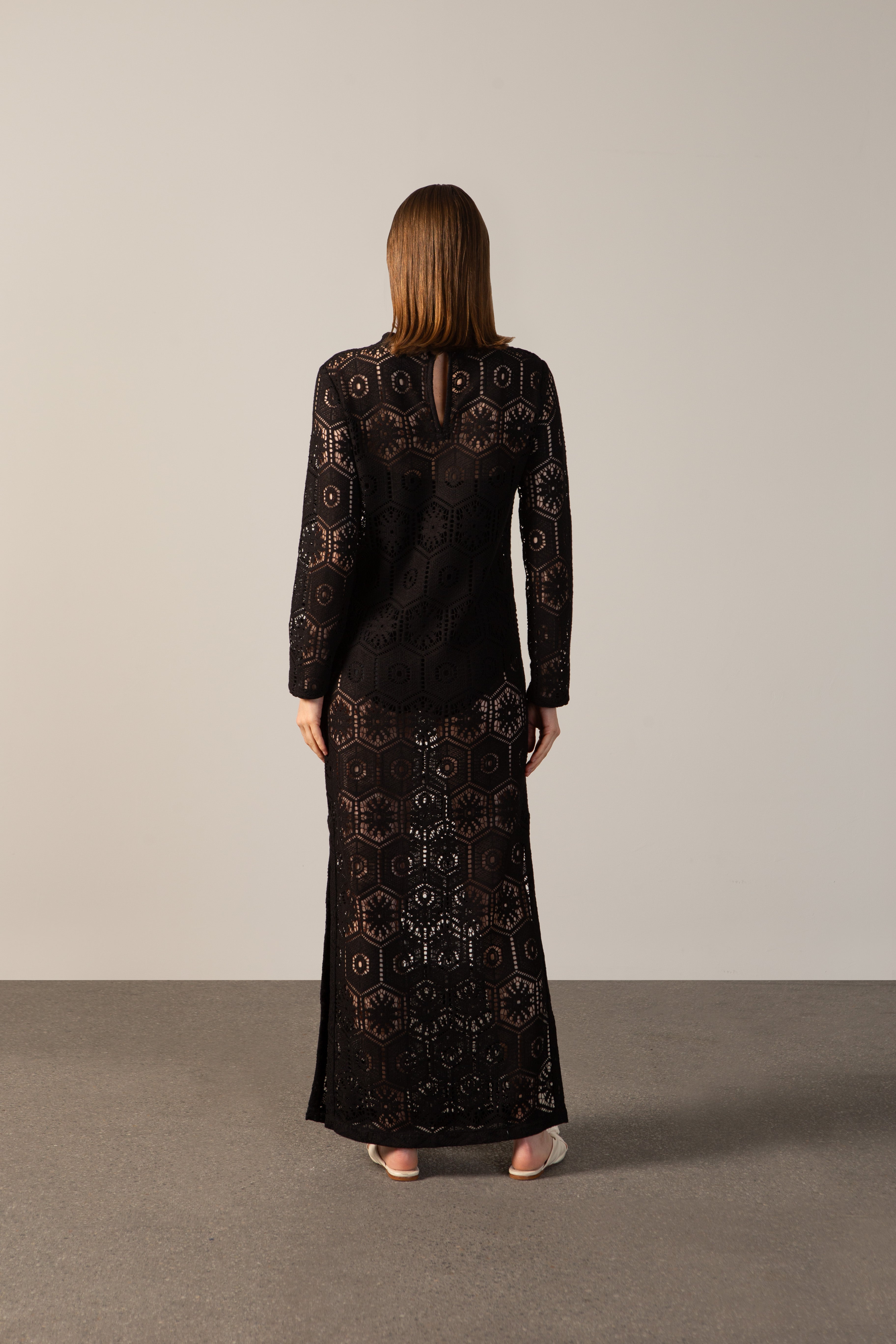 Model wearing the Lace Long-Sleeved Dress Back showcasing its Black color on 80% Polyester 20% Cotton fabric.