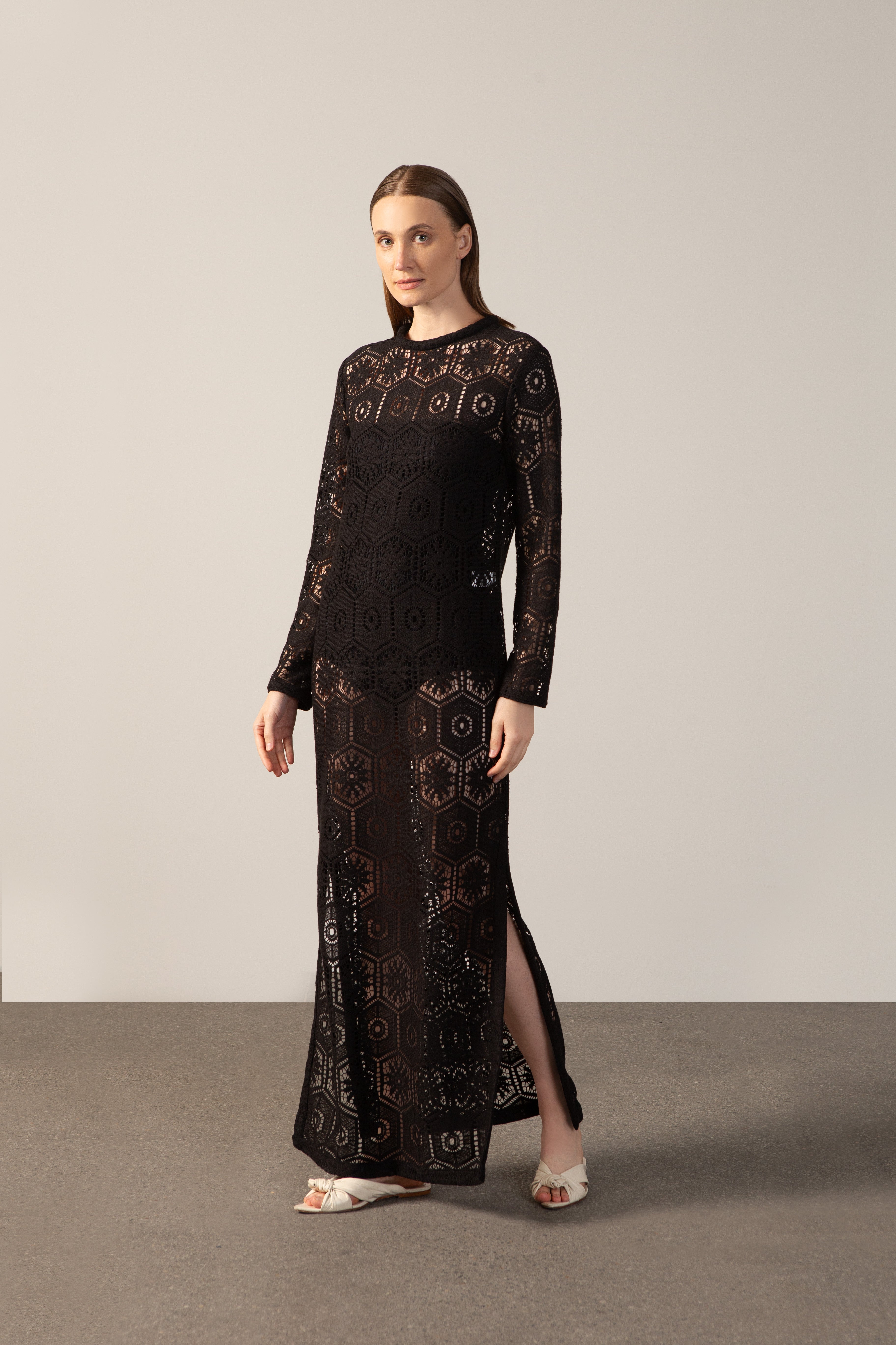 Model wearing the Lace Long-Sleeved Dress Front showcasing its Black color on 80% Polyester 20% Cotton fabric.