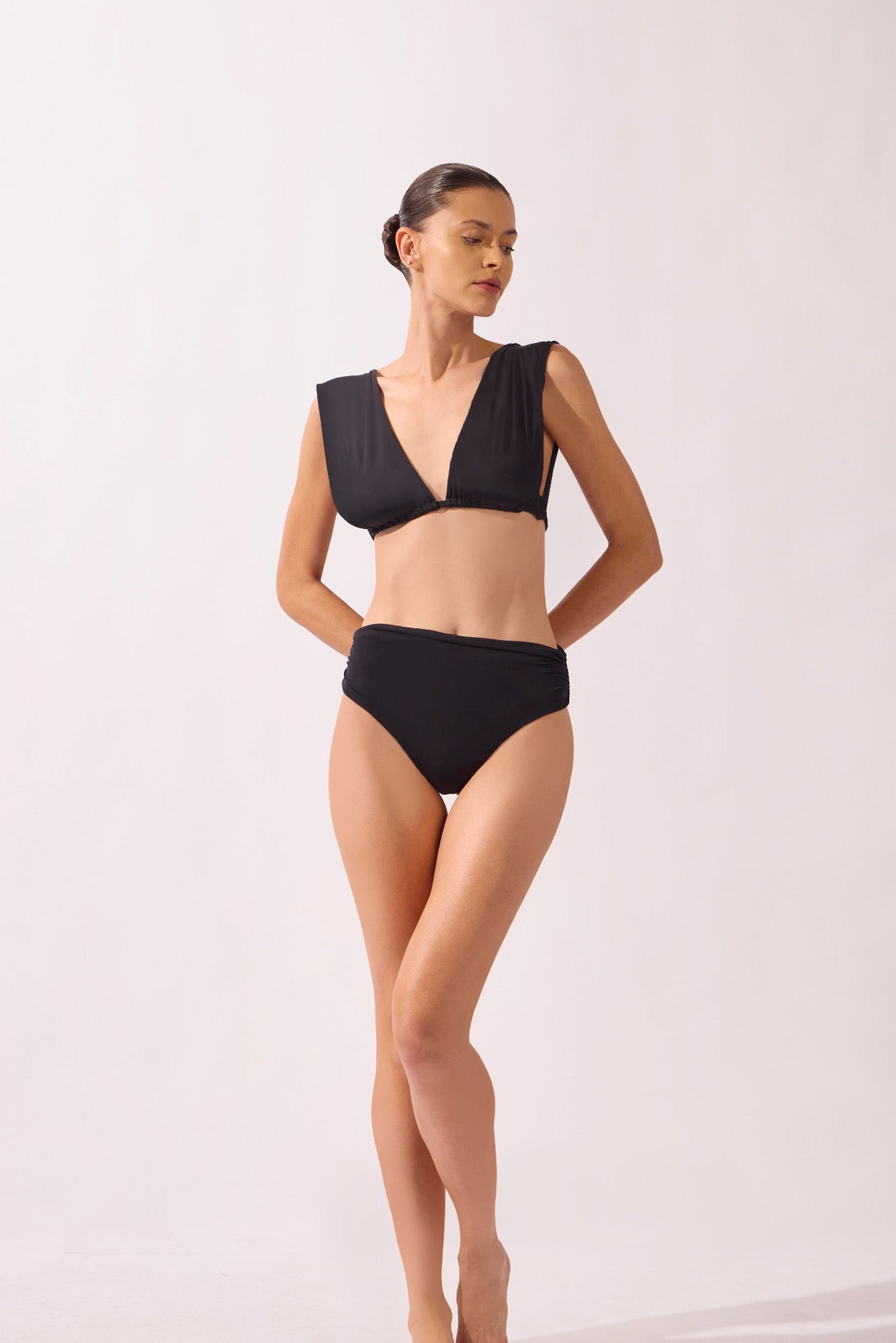 Model wearing the Lace-Up Back Bikini detail color black, made from 85% polyamide 15% elastane, styled for a beachwear look