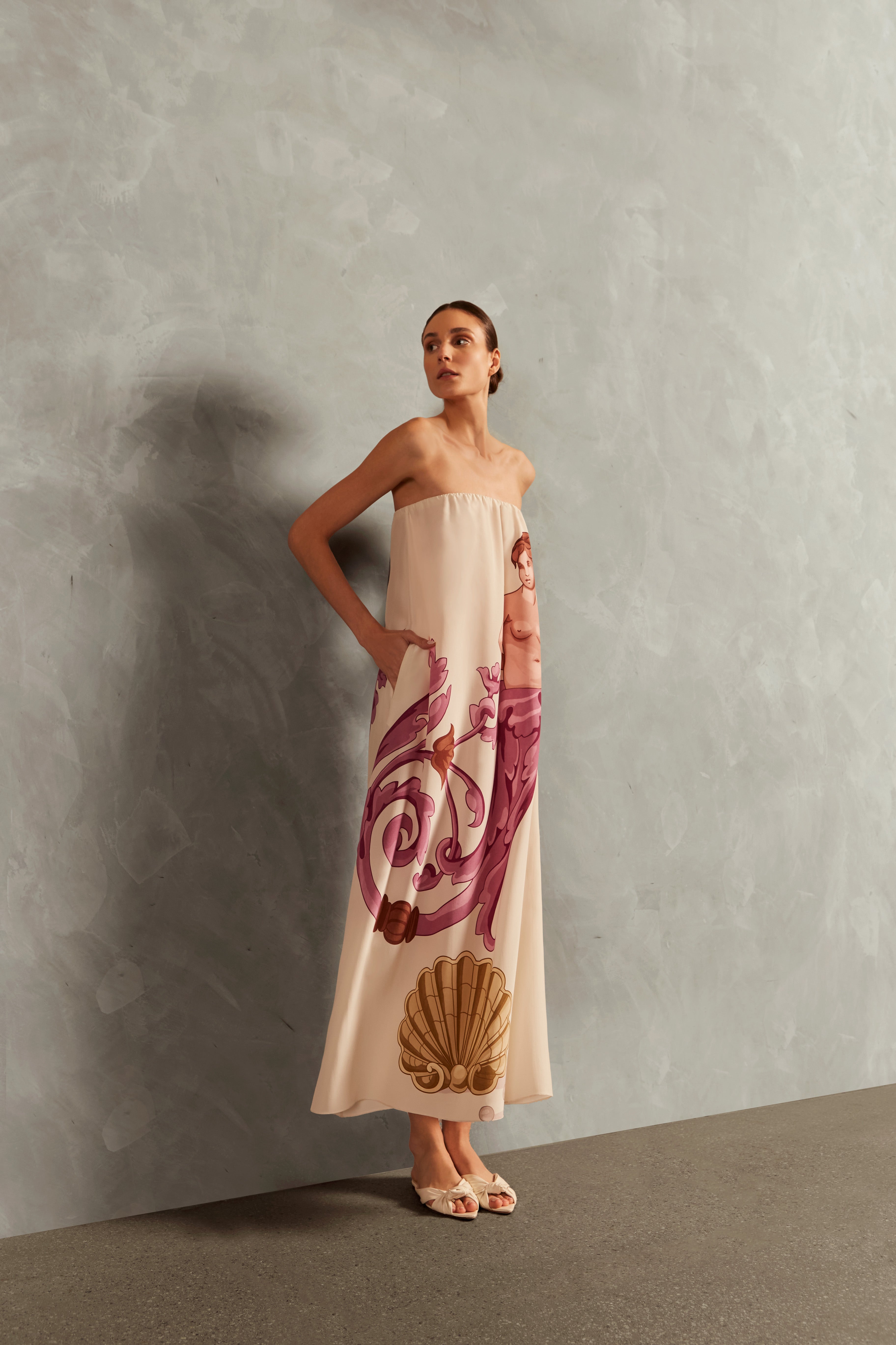 Model wearing the Le Sirenuse Strapless Long Dress Concept showcasing its Lilac color on 100% Silk fabric, styled for an afternoon look.