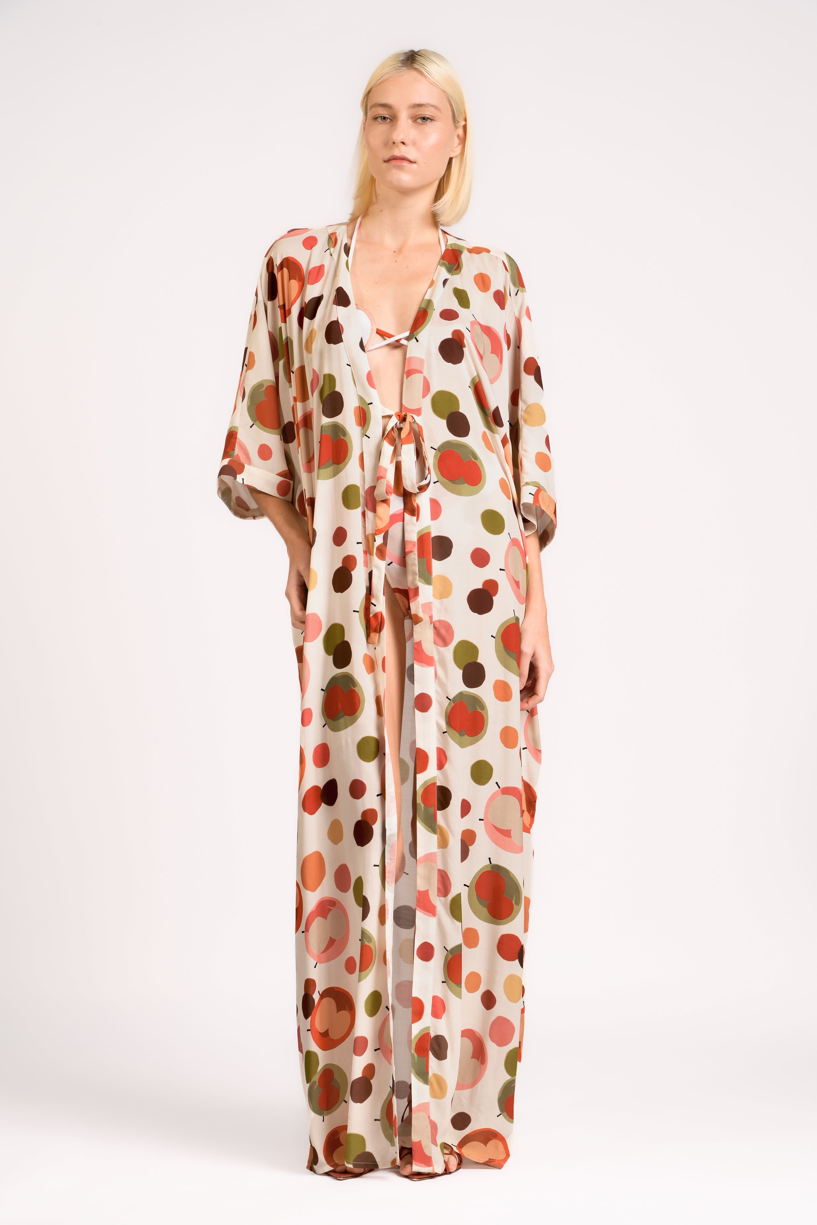 Model wearing the Lina Maxi Robe front color unique, made from 100% viscose, styled for beachwear look