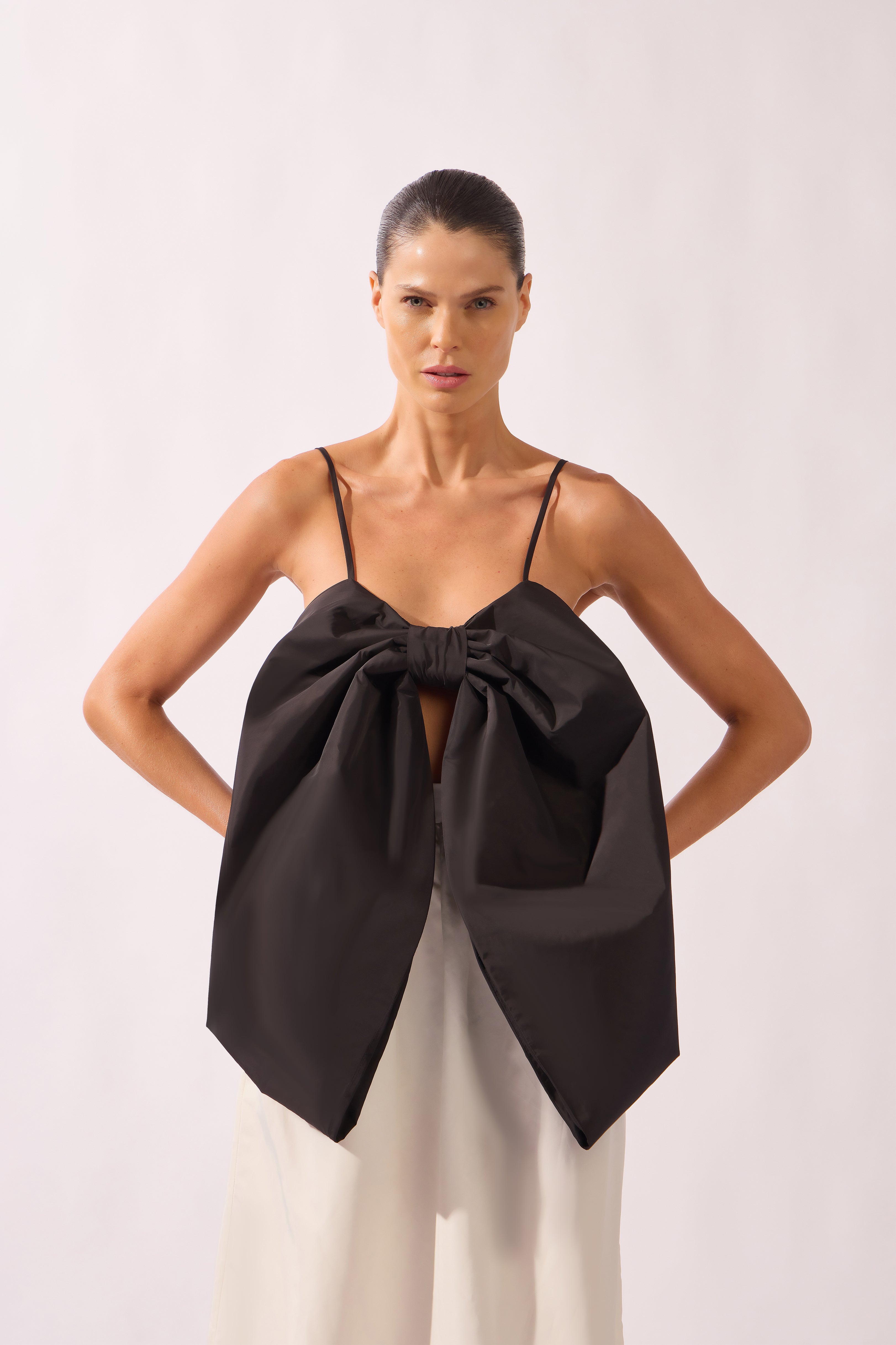 Model wearing the Solid Maxi Skirt front color black, made from 95% polyester 05% elastane, styled for a dinner look