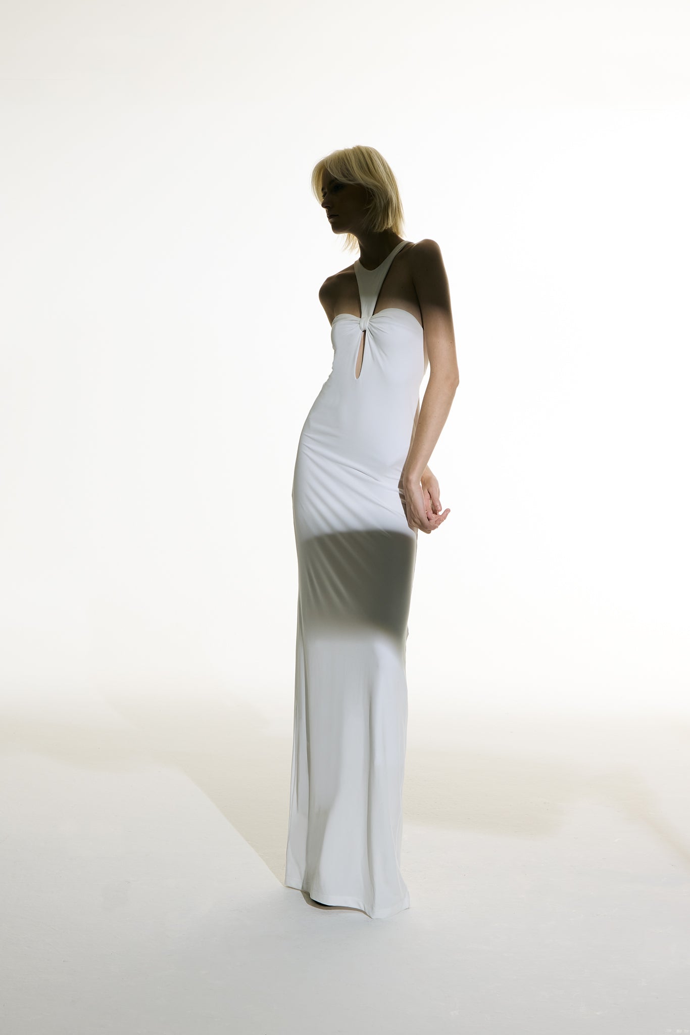 Model wearing the Open Back Maxi Dress off white front from the Adriana Degreas and Sabine Getty collab with 96% Viscose 4% Elastane styled for a evening look.