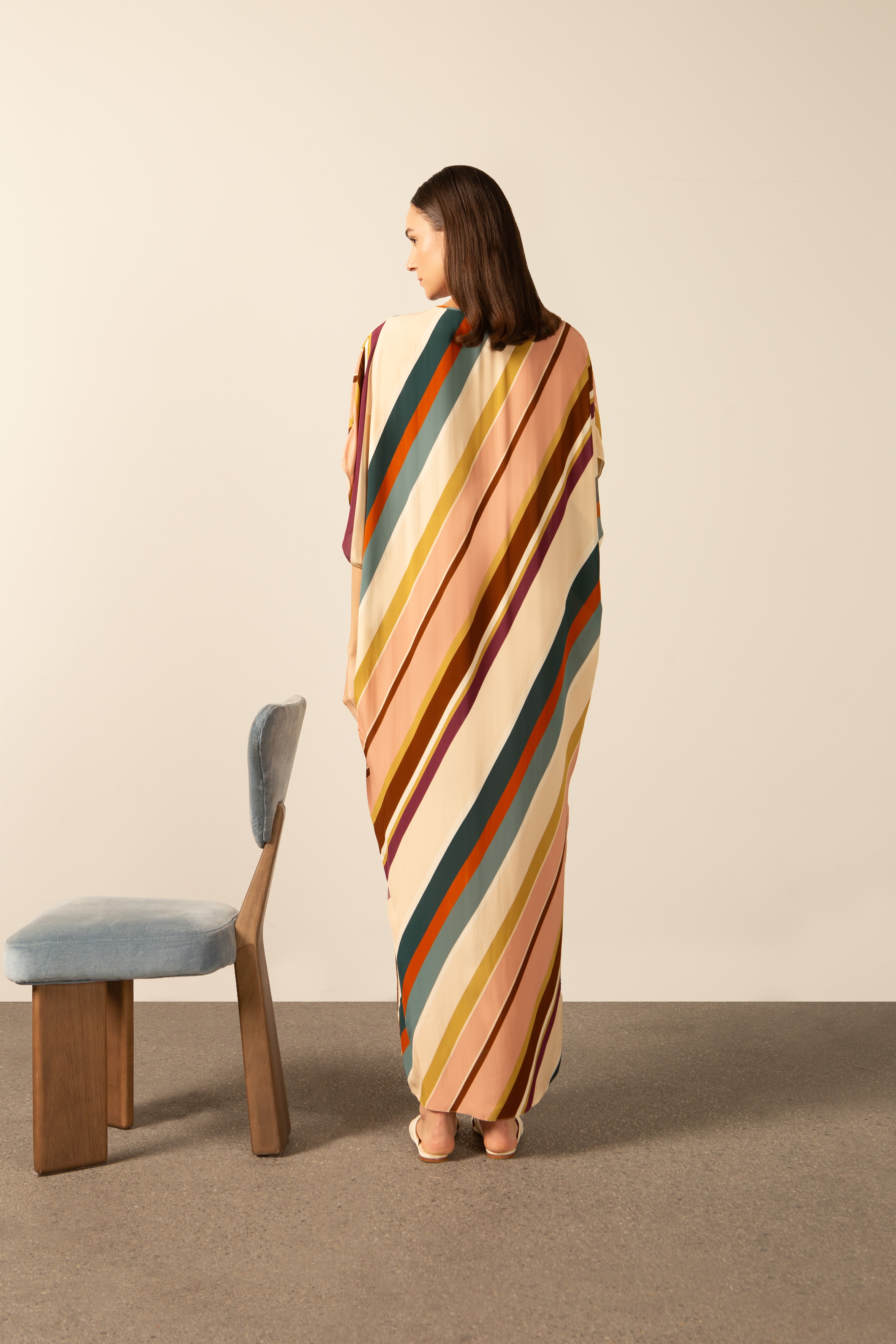Model wearing the Organic Stripes Long Kaftan unique color back from the HS25 with100% viscose styled for a lunch look.