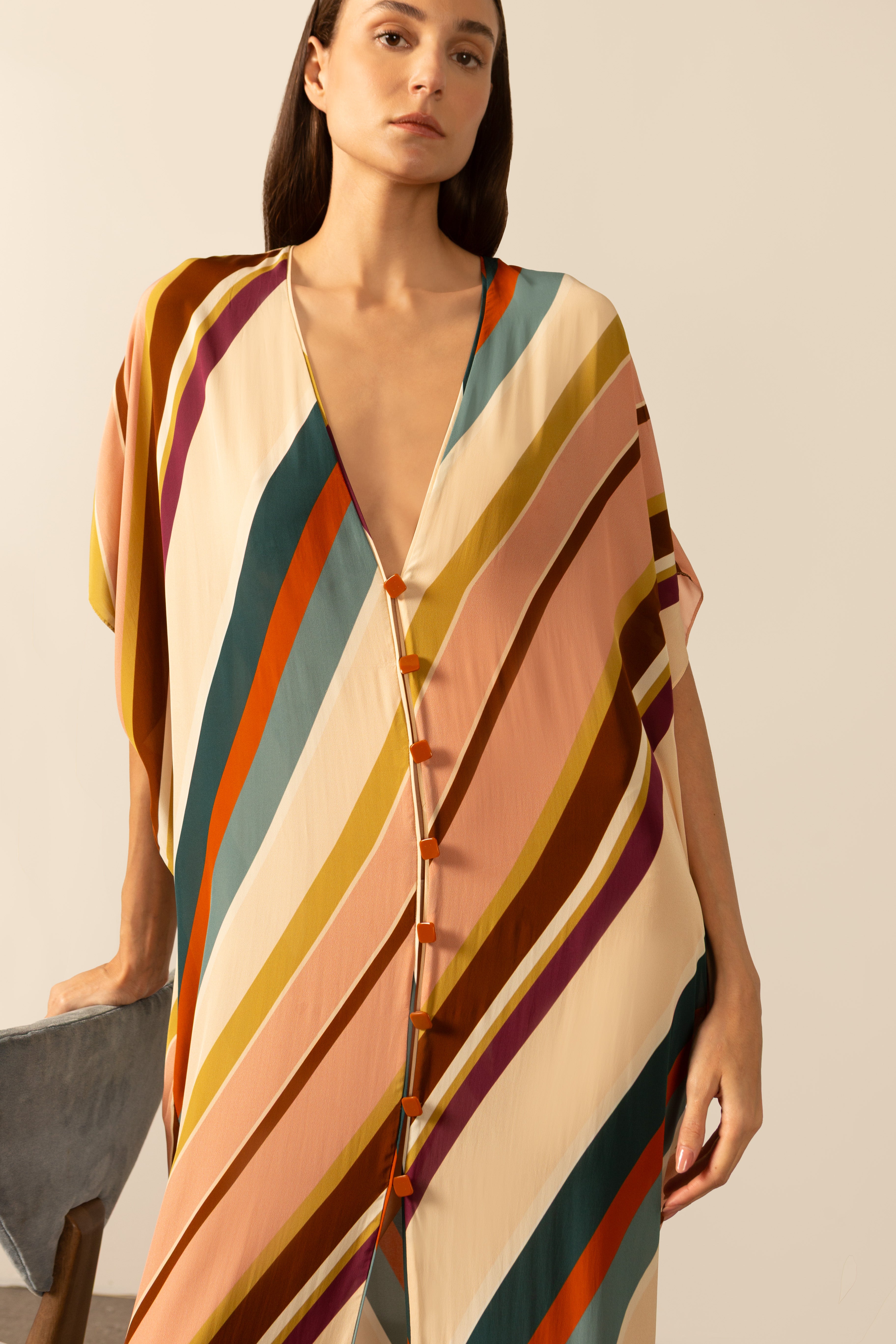 Model wearing the Organic Stripes Long Kaftan unique color detail from the HS25 with100% viscose styled for a lunch look.