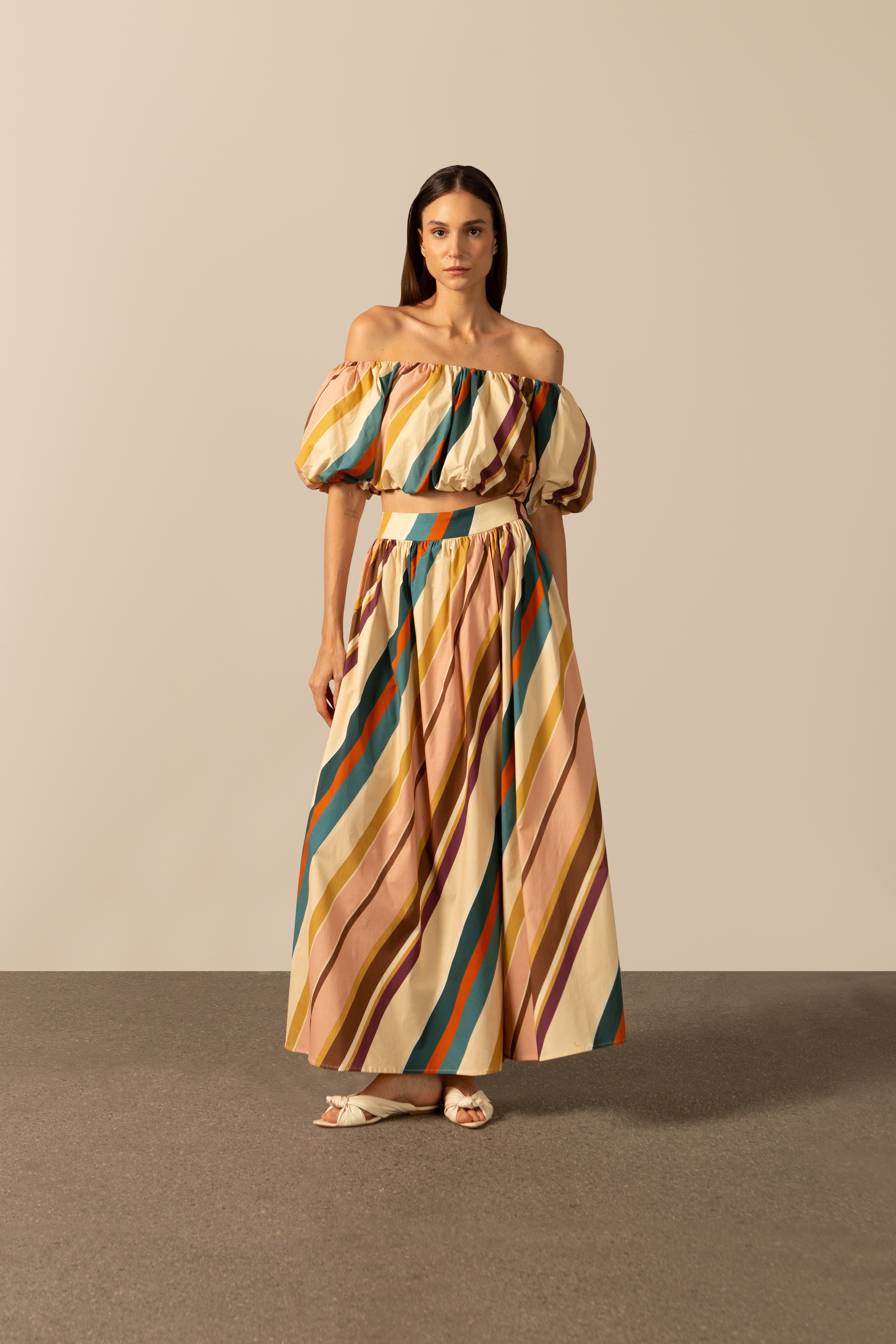 Model wearing the Organic Stripes Off-The-Shoulder Blouse unique color front from the HS25 with 97% Cotton 03% Elastane styled for a lunch look.