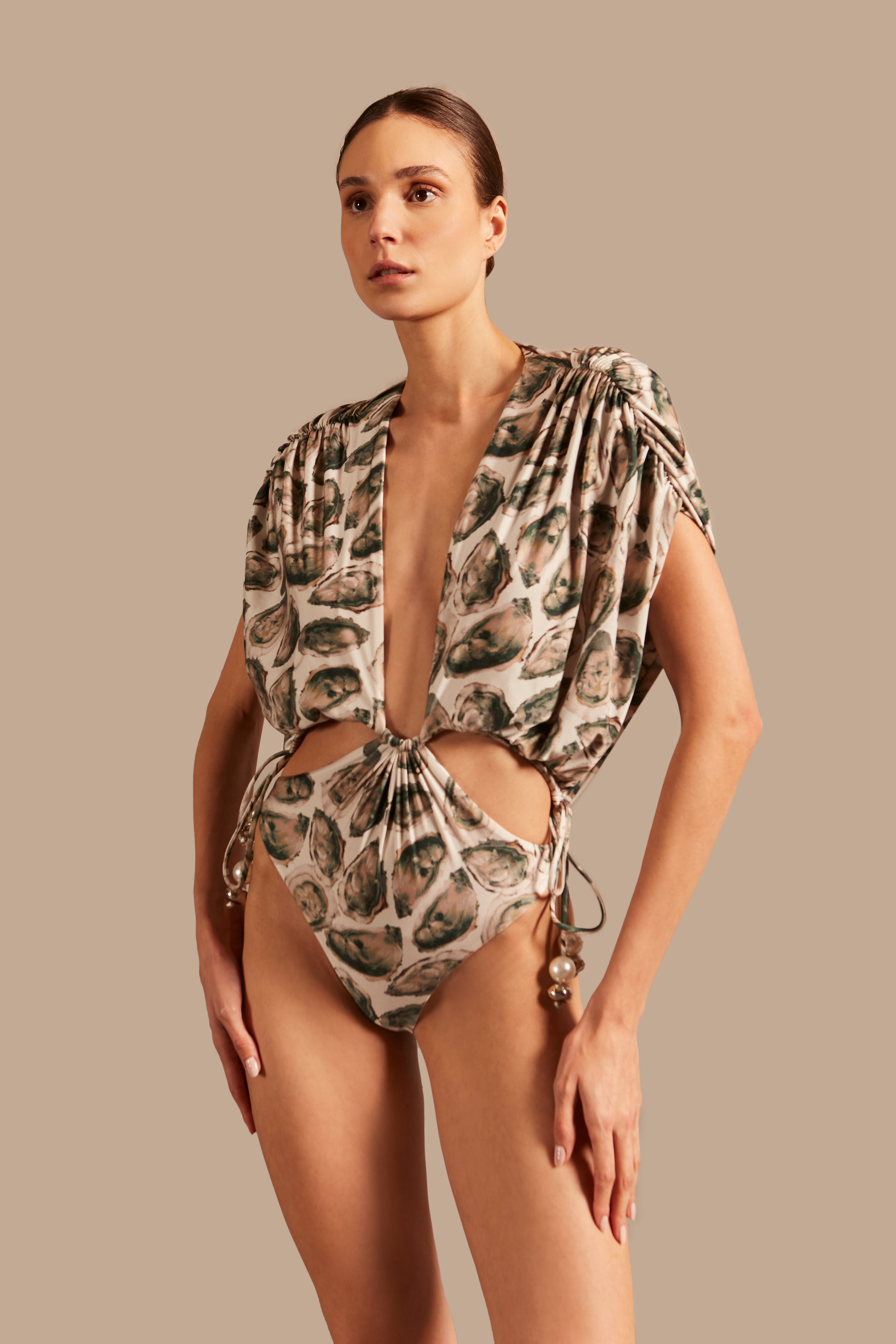 Model wearing the Oysters High-Leg Bodysuit showcasing the close up of it's deep neckline piece with Oysters Print, on a stretchy fabric.