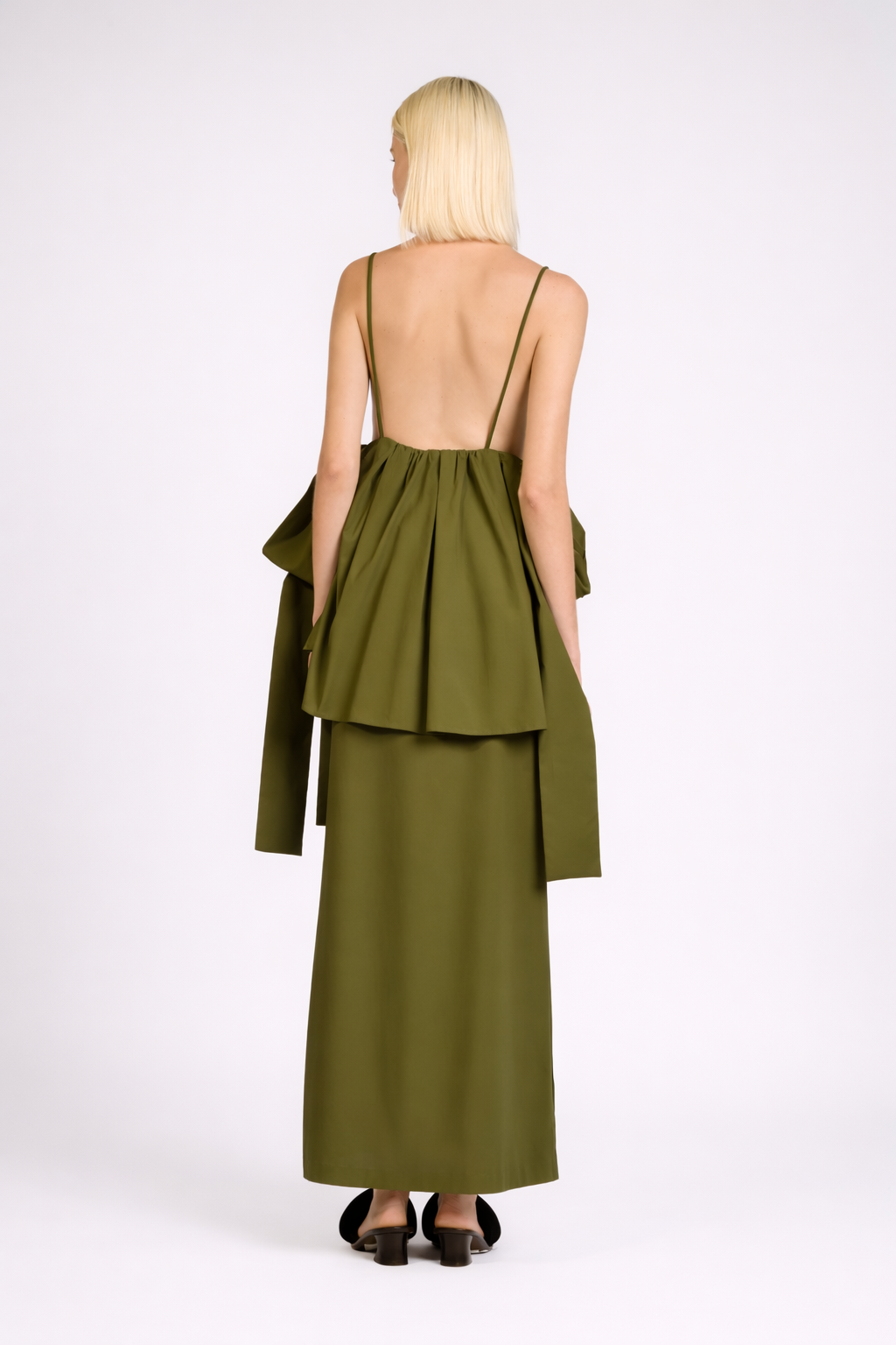 Model wearing the Peplum Maxi Dress back color green, made from 98% cotton 2% elastane, styled for resort look