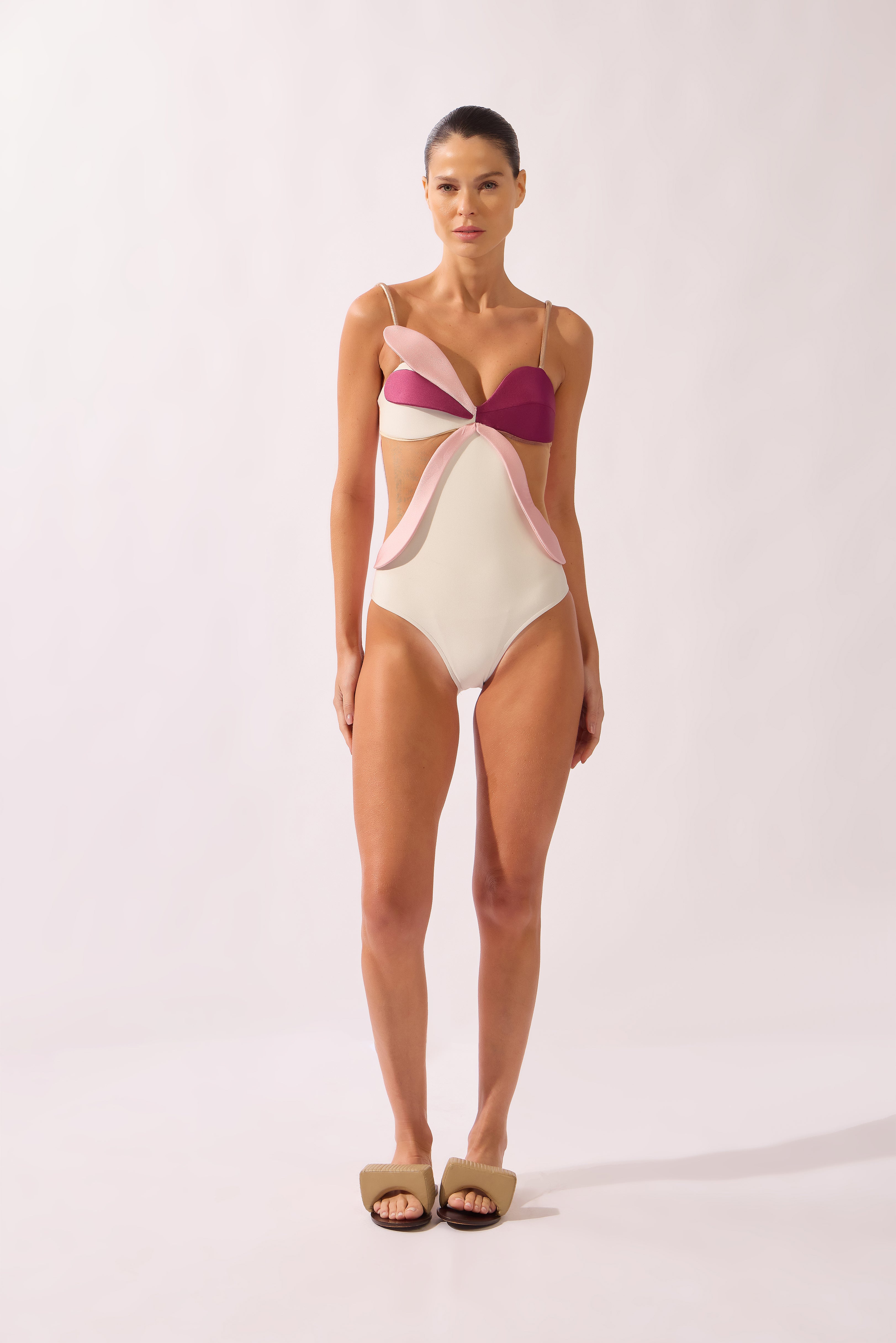 Model wearing the Petal Appliqué Swimsuit front color unique, made from 85% polyamide 15% elastane, styled for a beachwear look