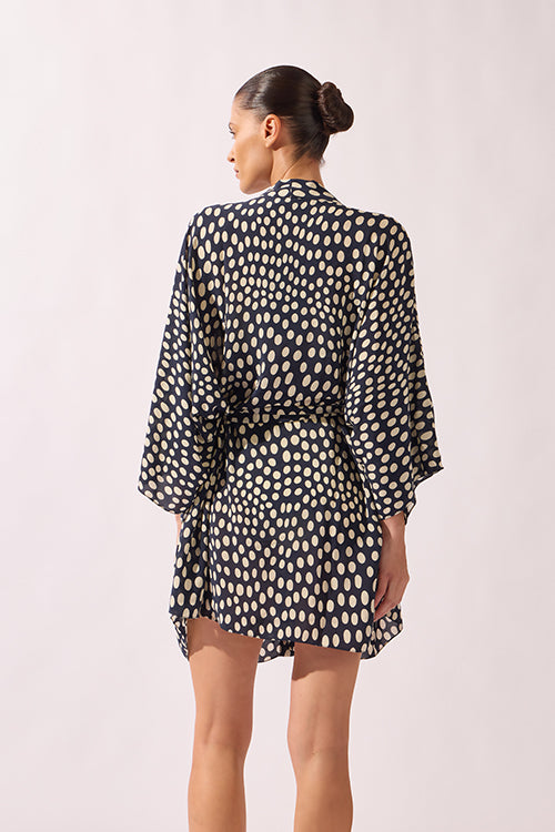 Model wearing Pois Short Robe back color navy, made from 100% viscose, styled for a resort look